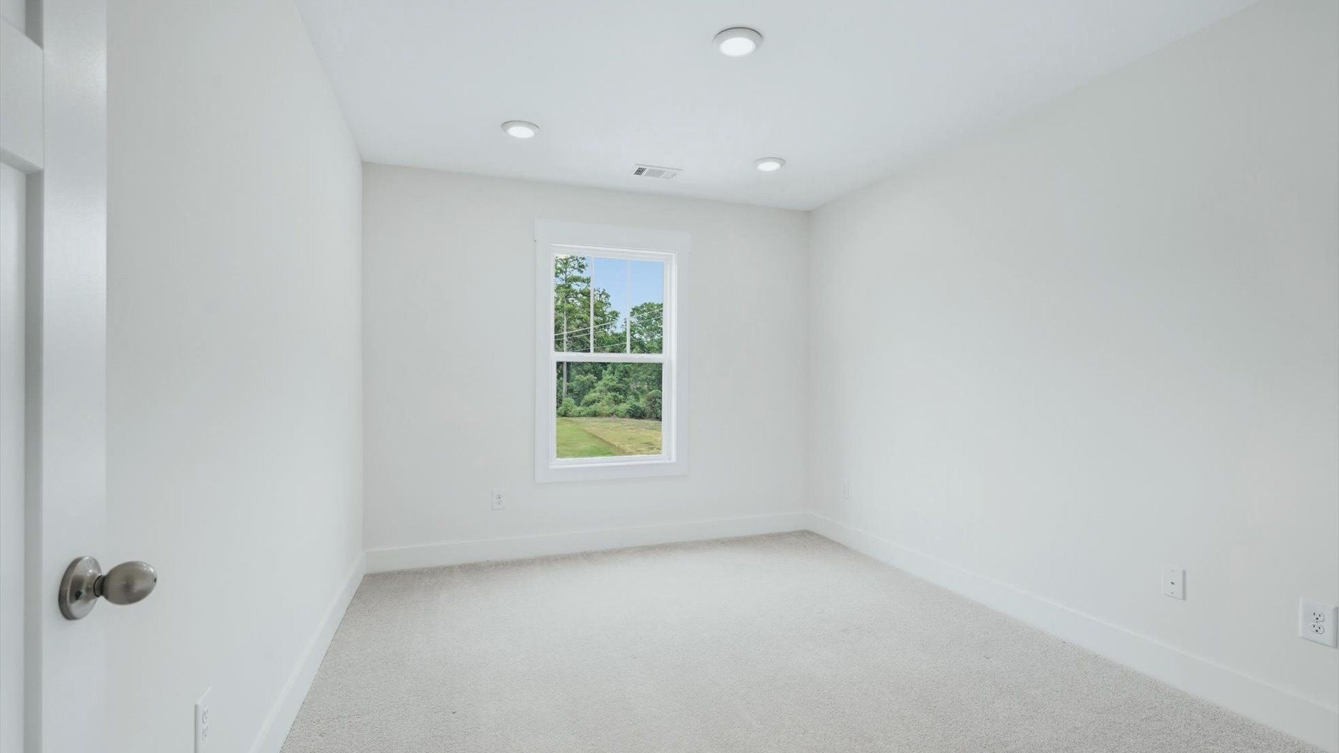 Inviting bedroom with tasteful finishes and large windows that create a fresh, open ambiance near Lake Hartwell