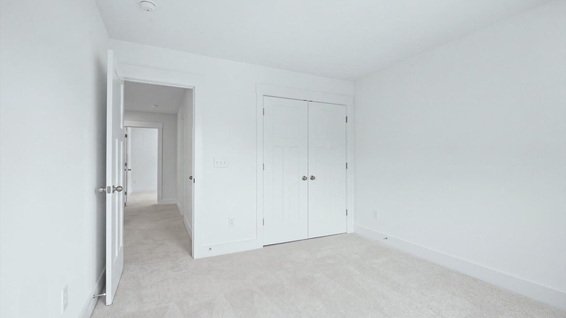 First-class secondary bedroom with comfortable carpeted flooring and generous closet space at Creeks at Midway
