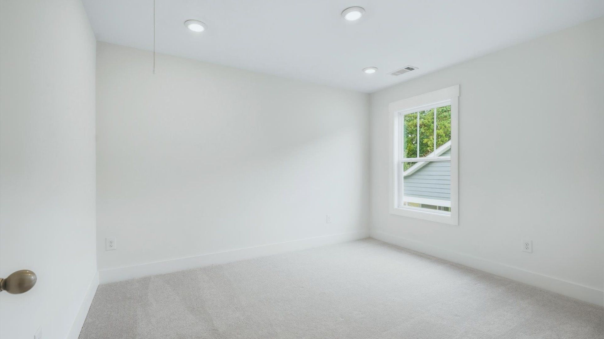 Bright and serene bedroom with comfortable carpeted flooring and large windows for vibrant light near Lake Hartwell