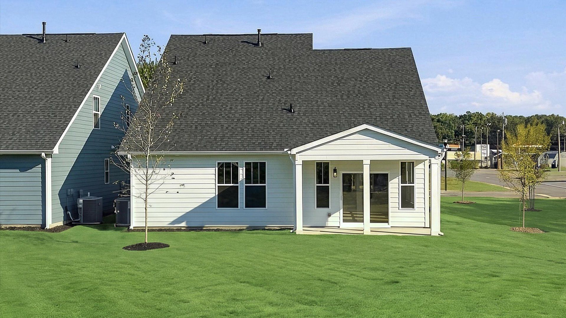 Warm and inviting outdoor living space with a covered rear porch and tasteful finishes at Barton Hollow