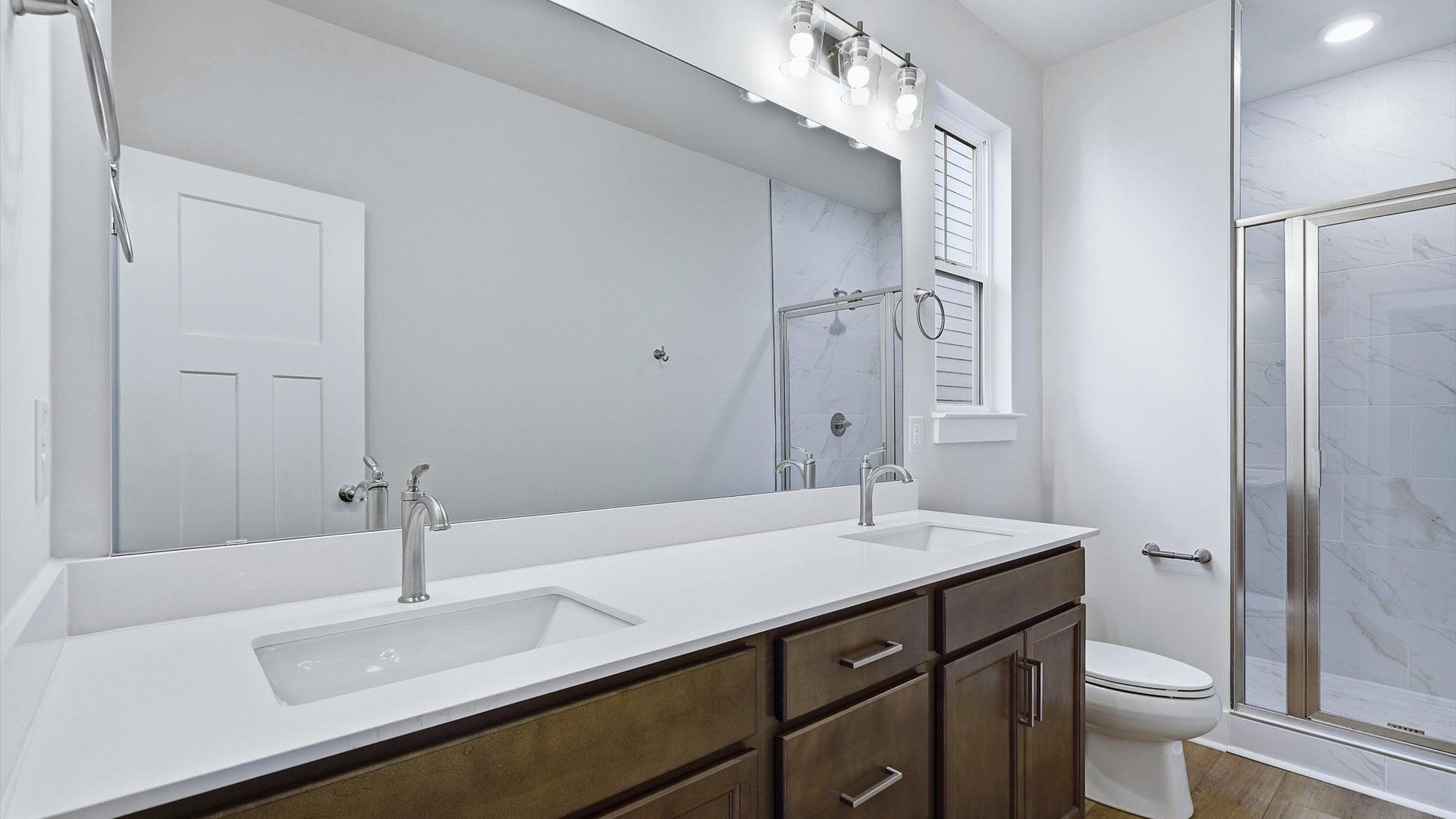 Notable primary suite with dual vanities and walk-in shower in this prime Fountain Inn home