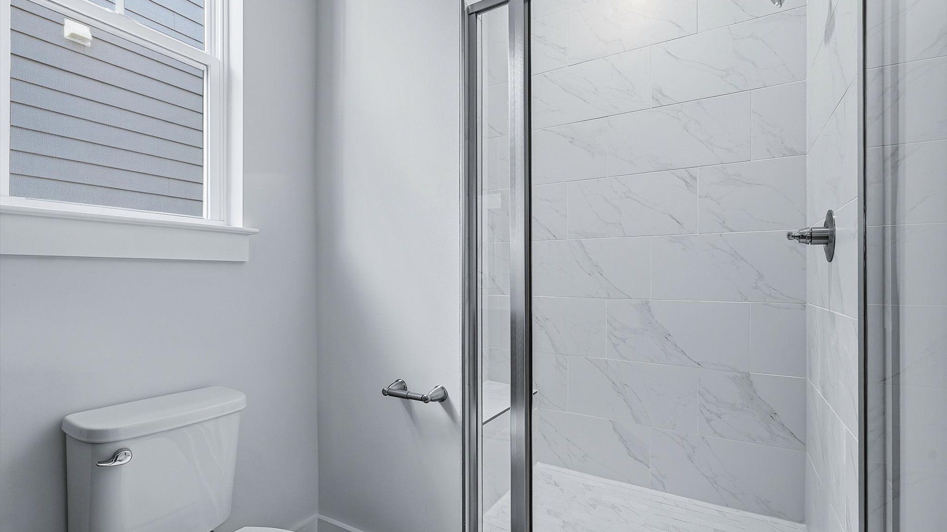 Notable primary bath featuring a walk-in shower and tasteful design touches throughout at the Barton Hollow community