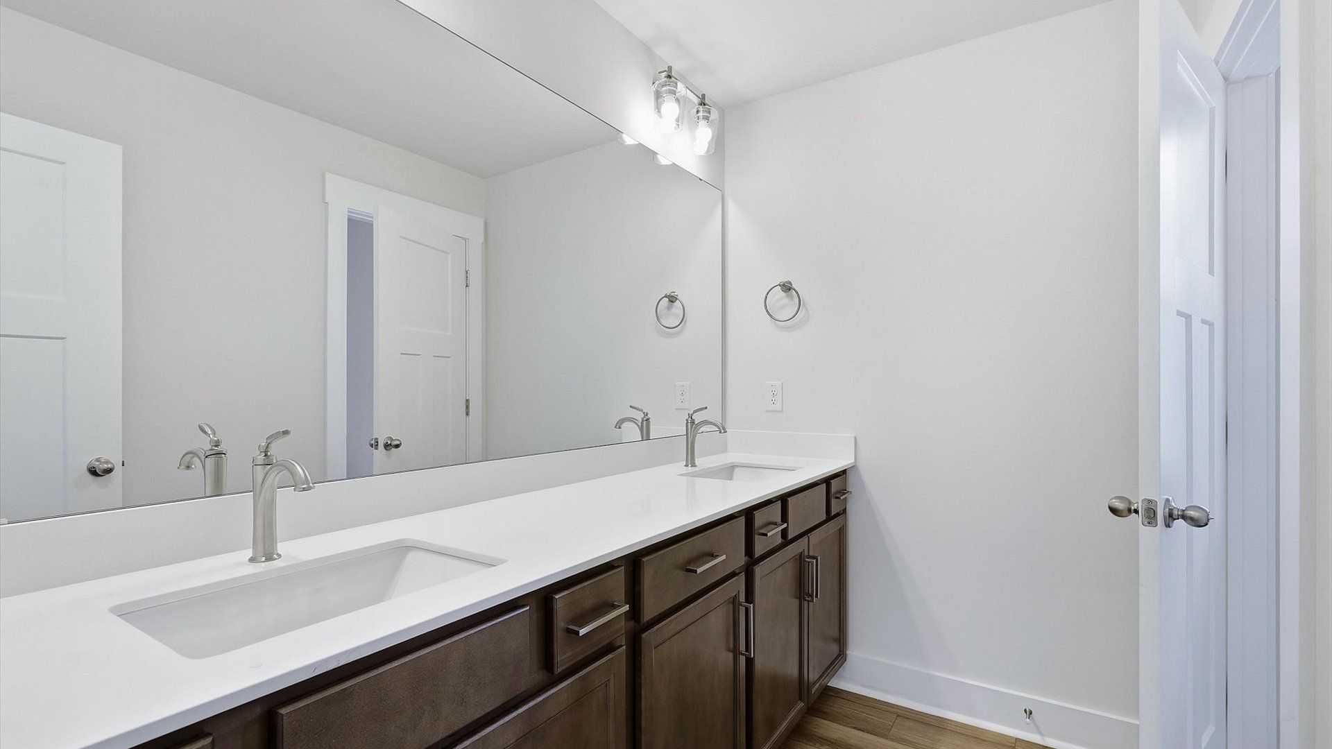 Accomplished bathroom design with sleek tile, high-quality cabinetry, and refined hardware at the Barton Hollow community