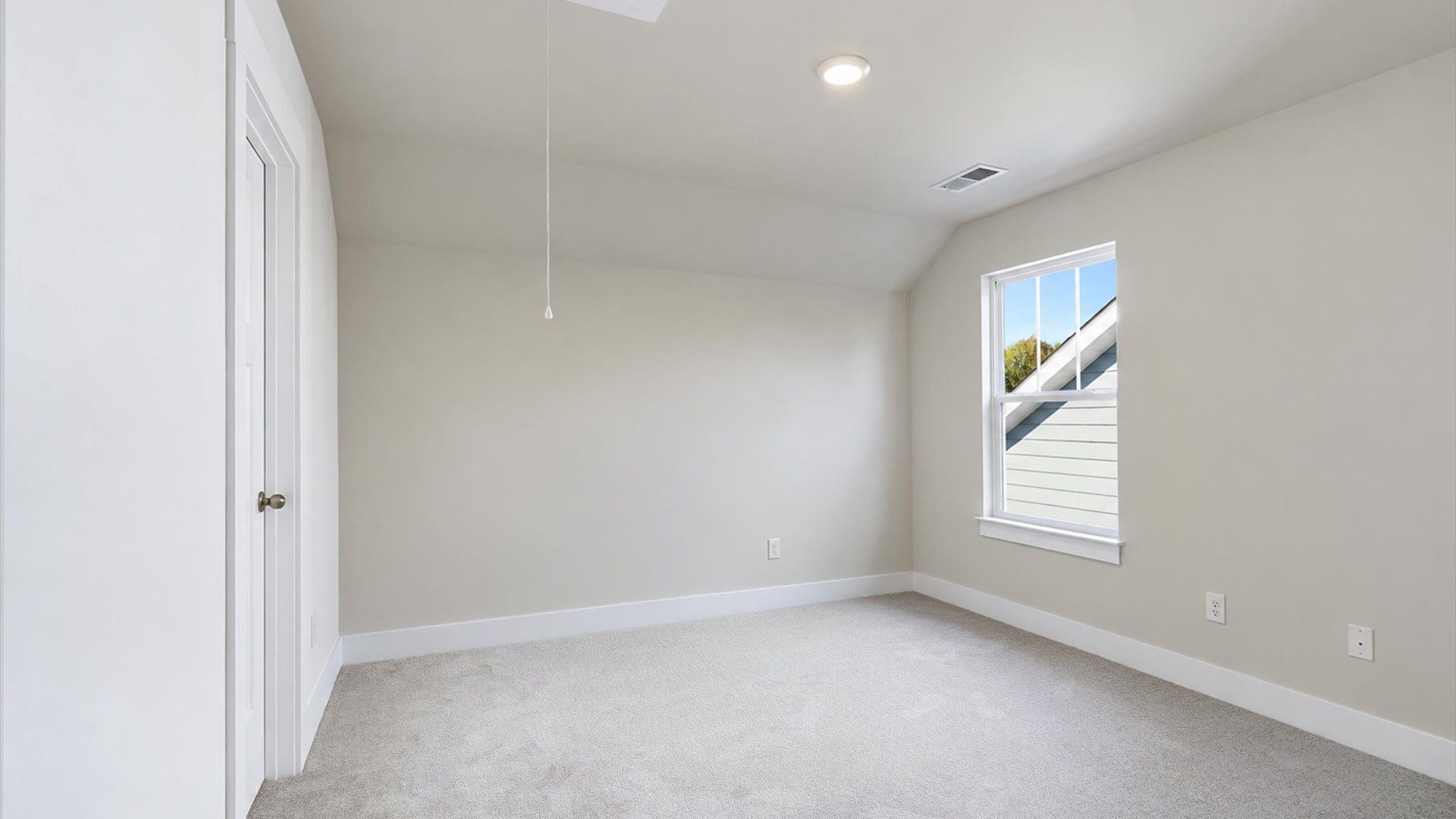 Bright and serene bedroom with comfortable carpeted flooring and a large window for vibrant light at Barton Hollow