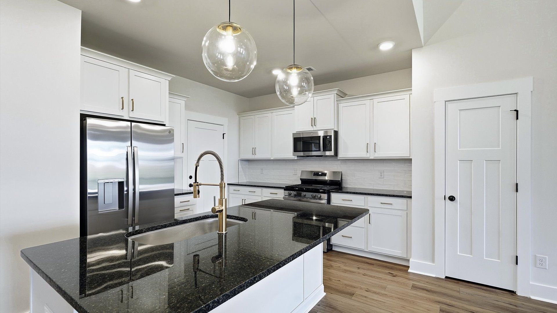 Elegant and compact island anchors this tasteful kitchen with high standards and timeless appeal by DRB Homes