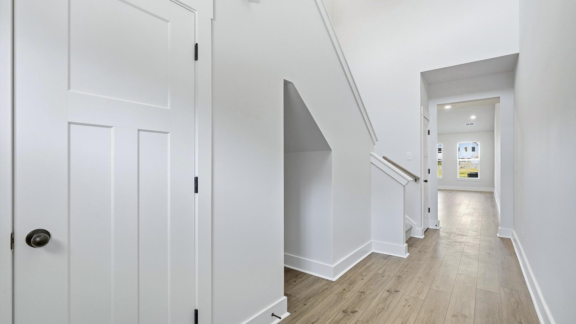 Superior design begins at the front door with a hardwood floor foyer and elegant sightlines at Barton Hollow