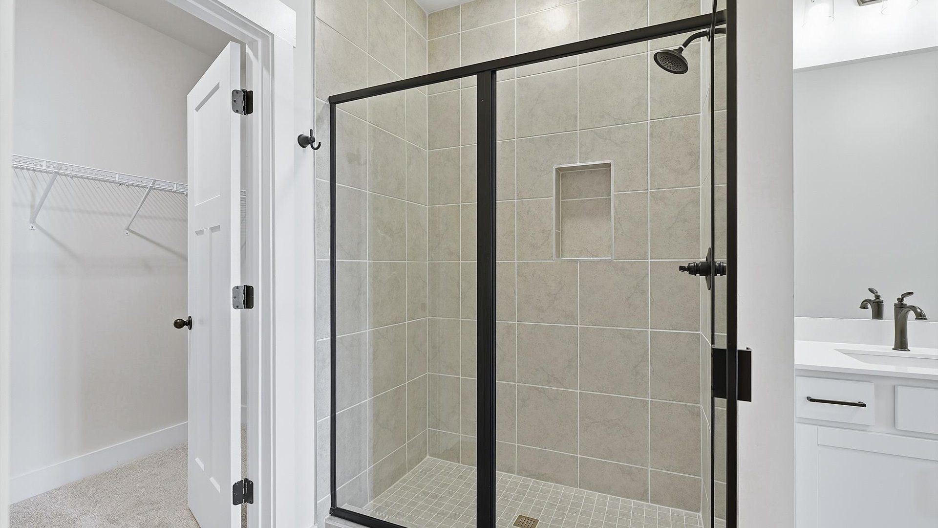 Superior en-suite primary bathroom with stylish walk-in shower—crafted with high standards in mind by DRB Homes