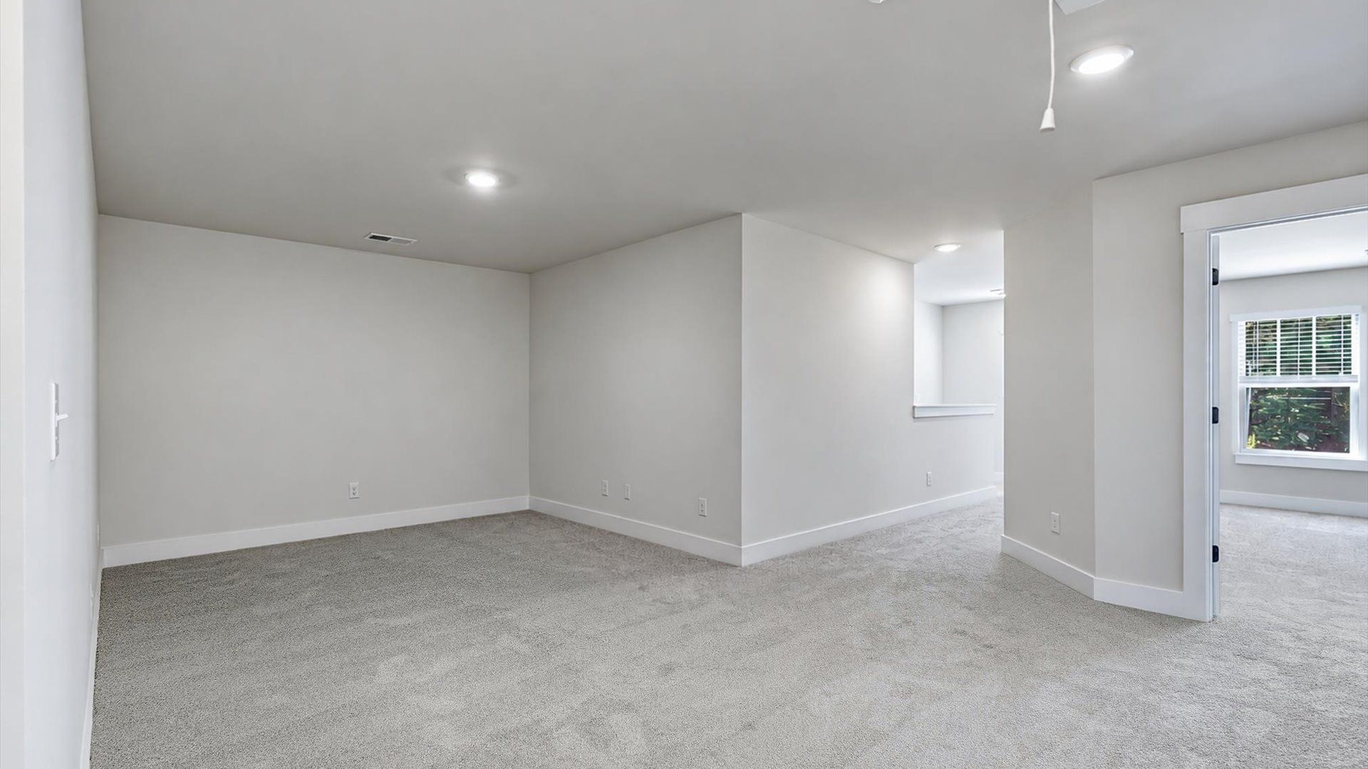Vibrant carpeted loft offering flexibility as a study nook, game room, or second family space at Barton Hollow