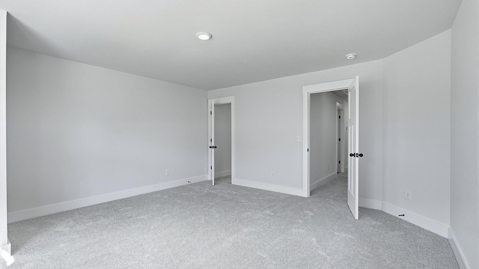 Elegant bedroom retreat featuring soft carpeting and a thoughtfully designed walk-in closet at Barton Hollow