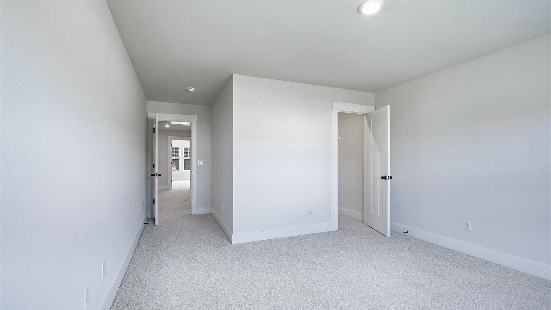Notable secondary bedroom offering cozy carpeted flooring and a stylish walk-in closet at Barton Hollow