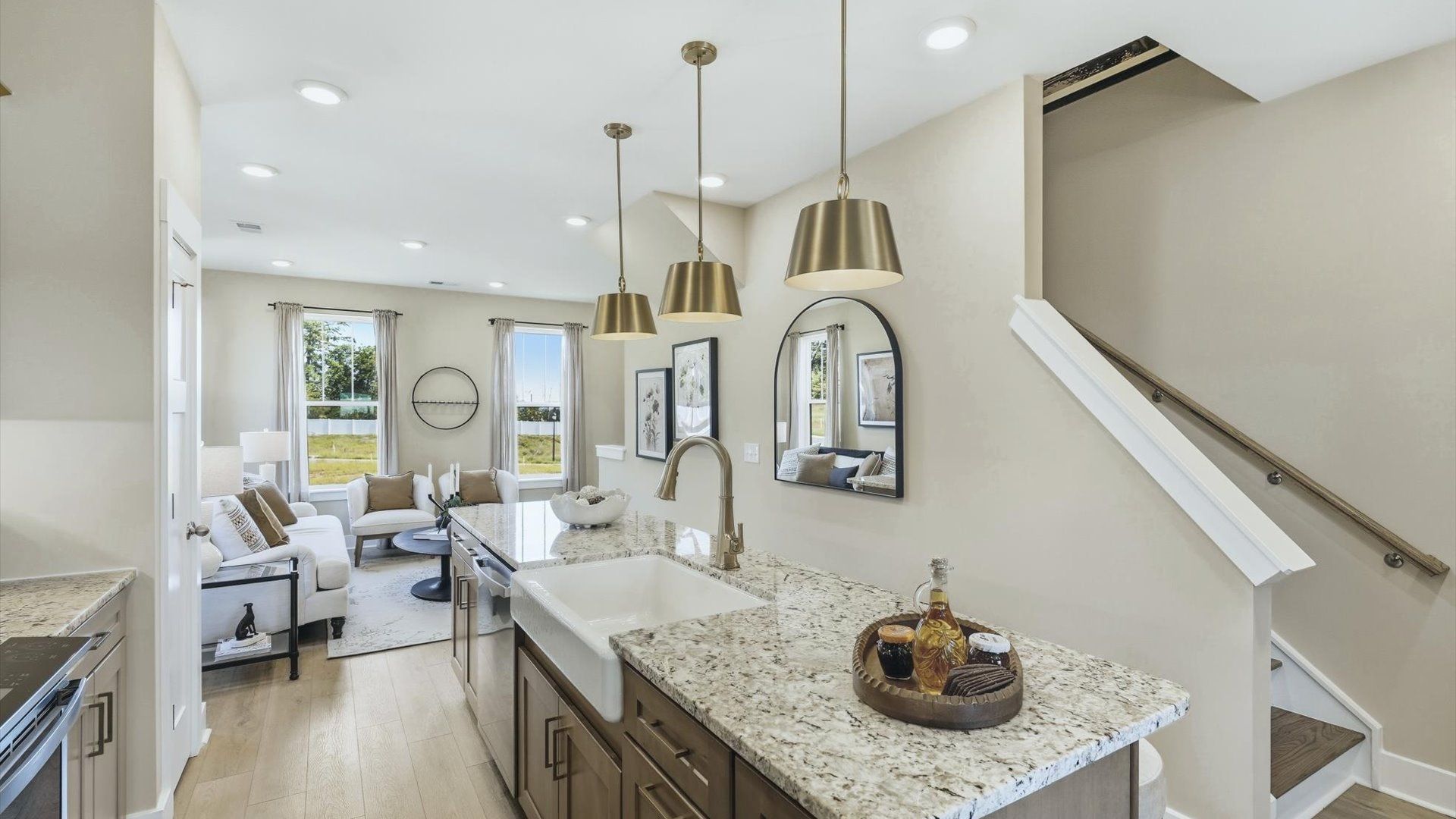 Elegant kitchen with large island and pendant lighting in this first-class DRB Homes design