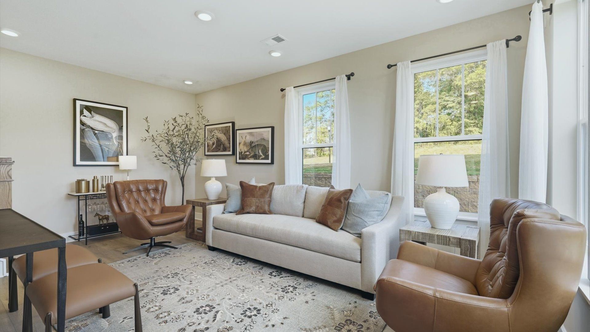 Memorable moments begin in this elegant, living room with hardwood flooring and refined finishes by DRB Homes
