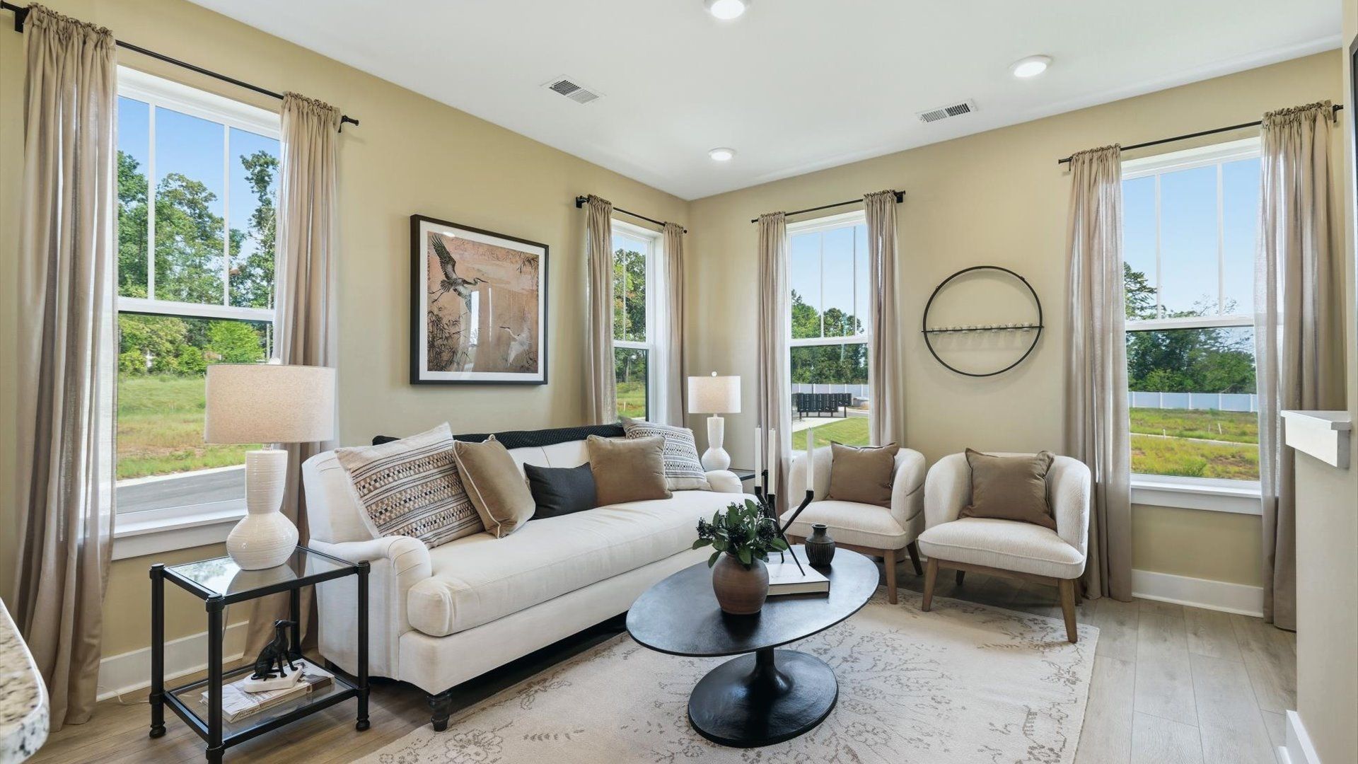 Hardwood flooring and high standards define this vibrant family room ideal for everyday living at Traynham Place