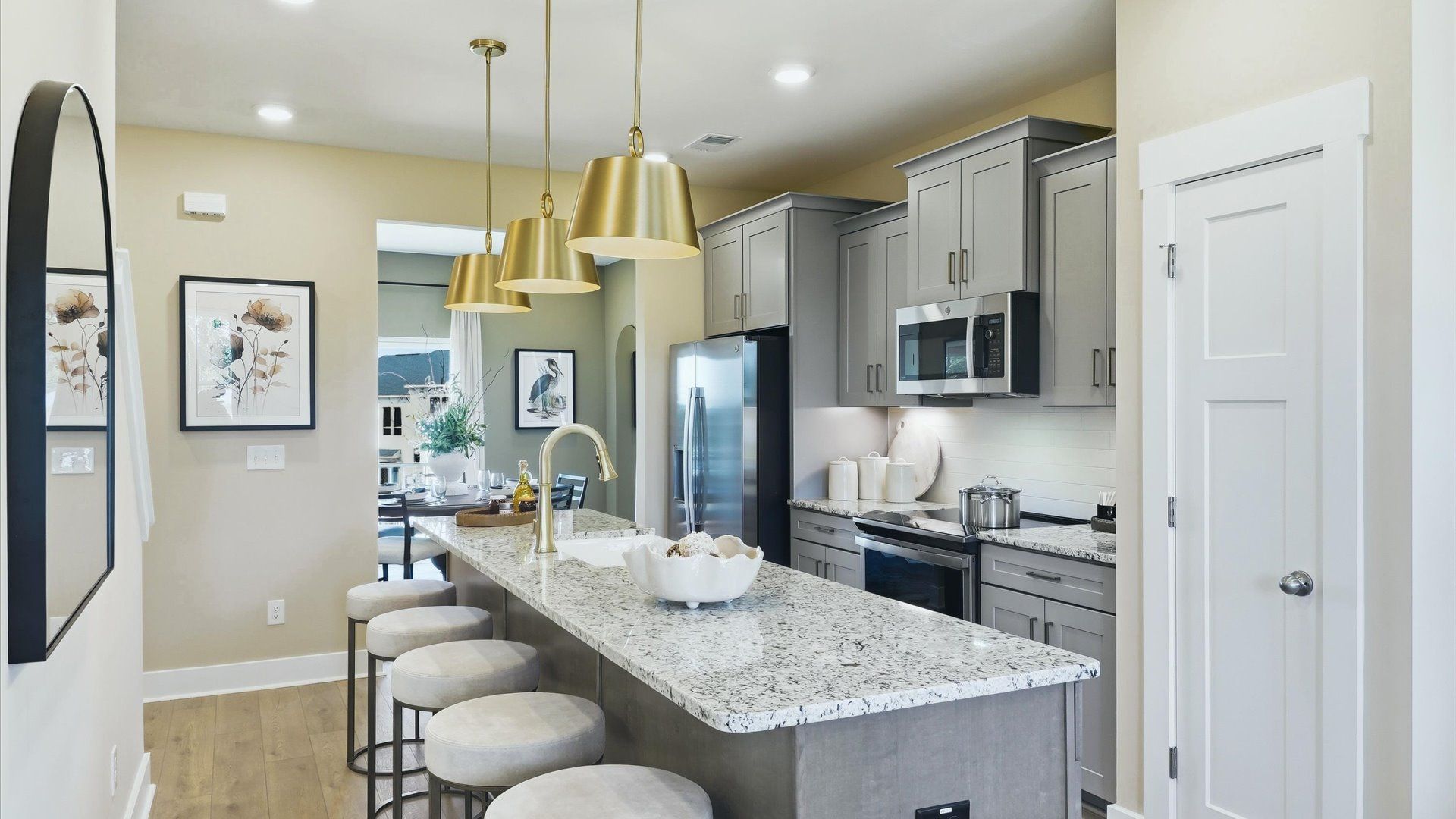 Vibrant kitchen layout with a center island, refined finishes, and open-concept flow by DRB Homes