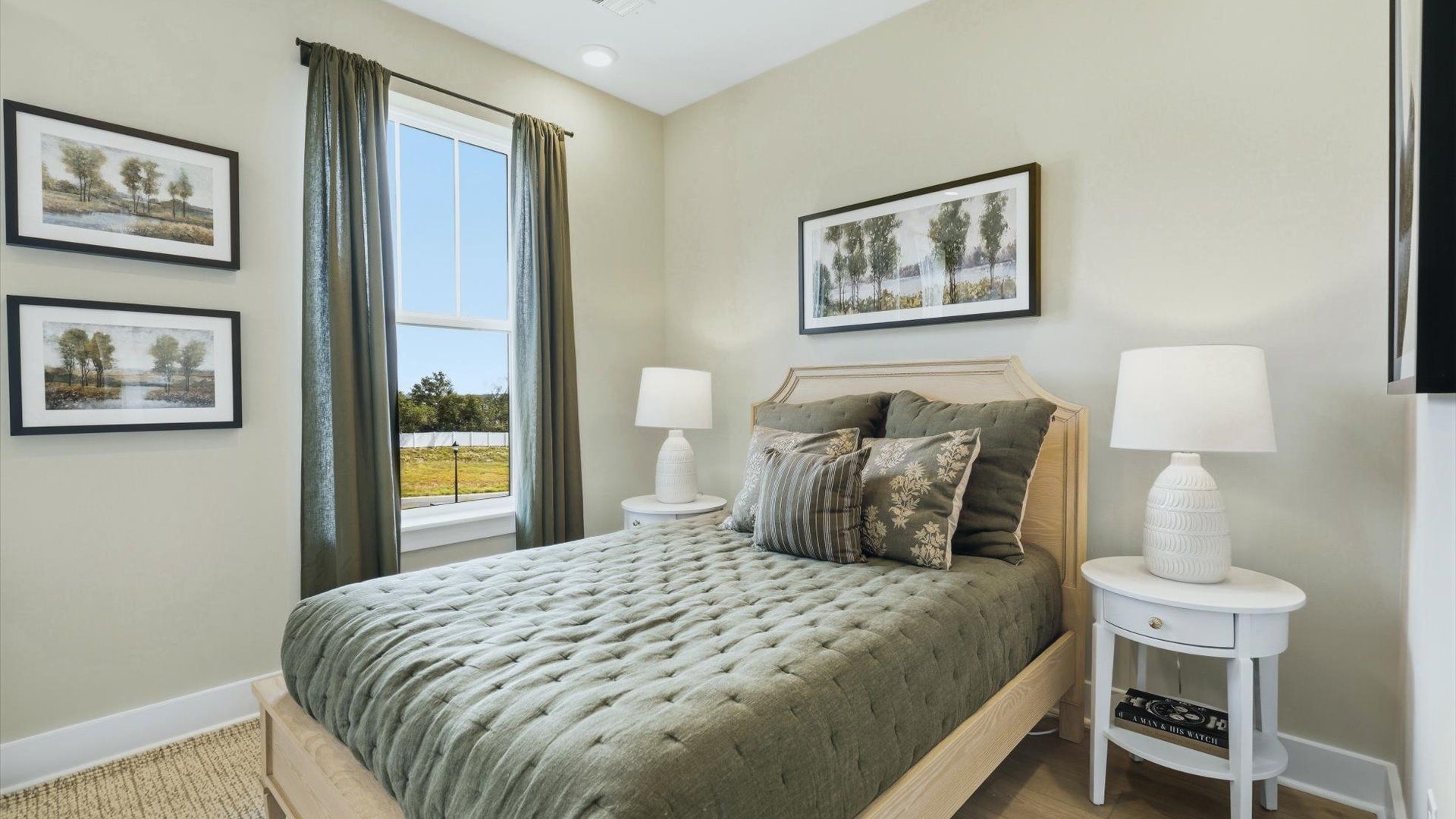 Functional secondary bedroom with hardwood flooring and modern touches in an exceptional layout