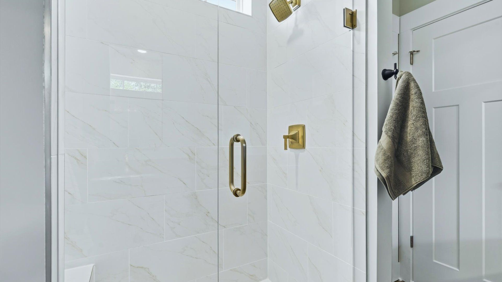 Superior en-suite primary bathroom with stylish walk-in shower—crafted with high standards in mind at Traynham Place