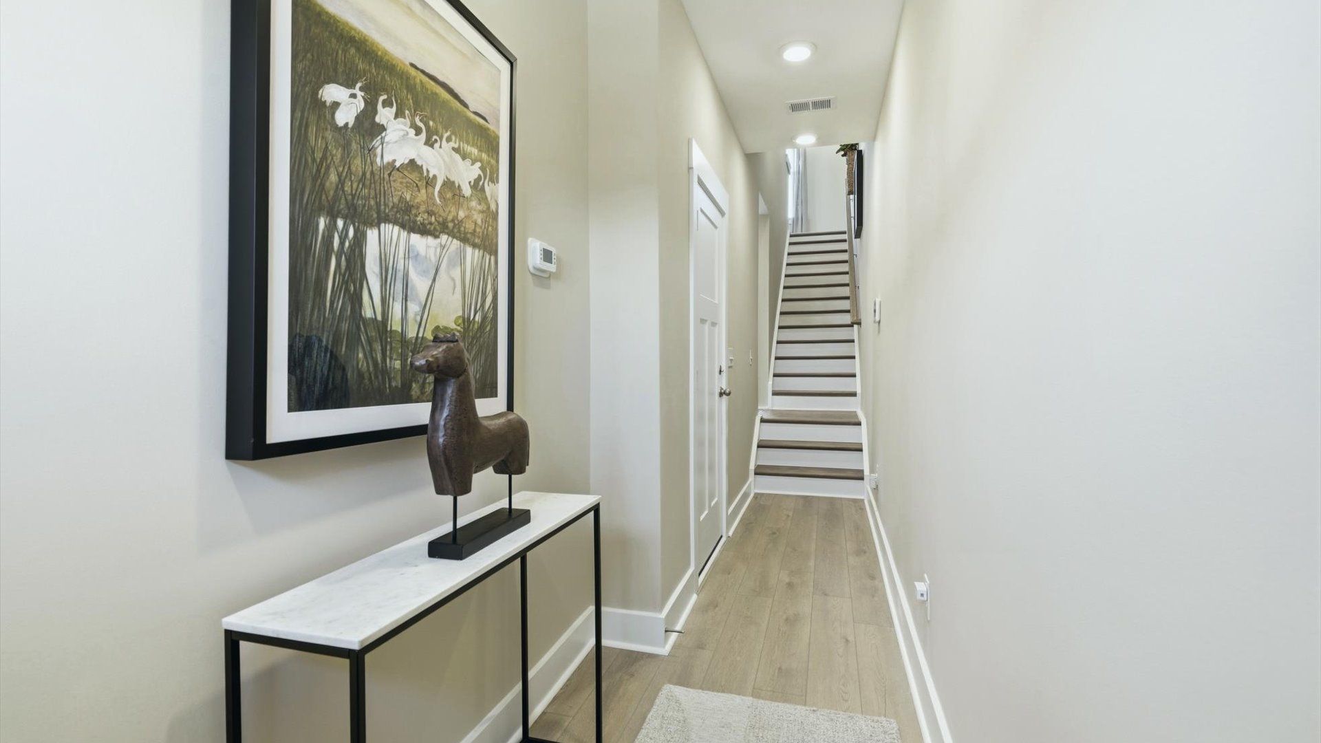 Superior design begins at the front door with a hardwood floor foyer and elegant sightlines near Downtown Greenville