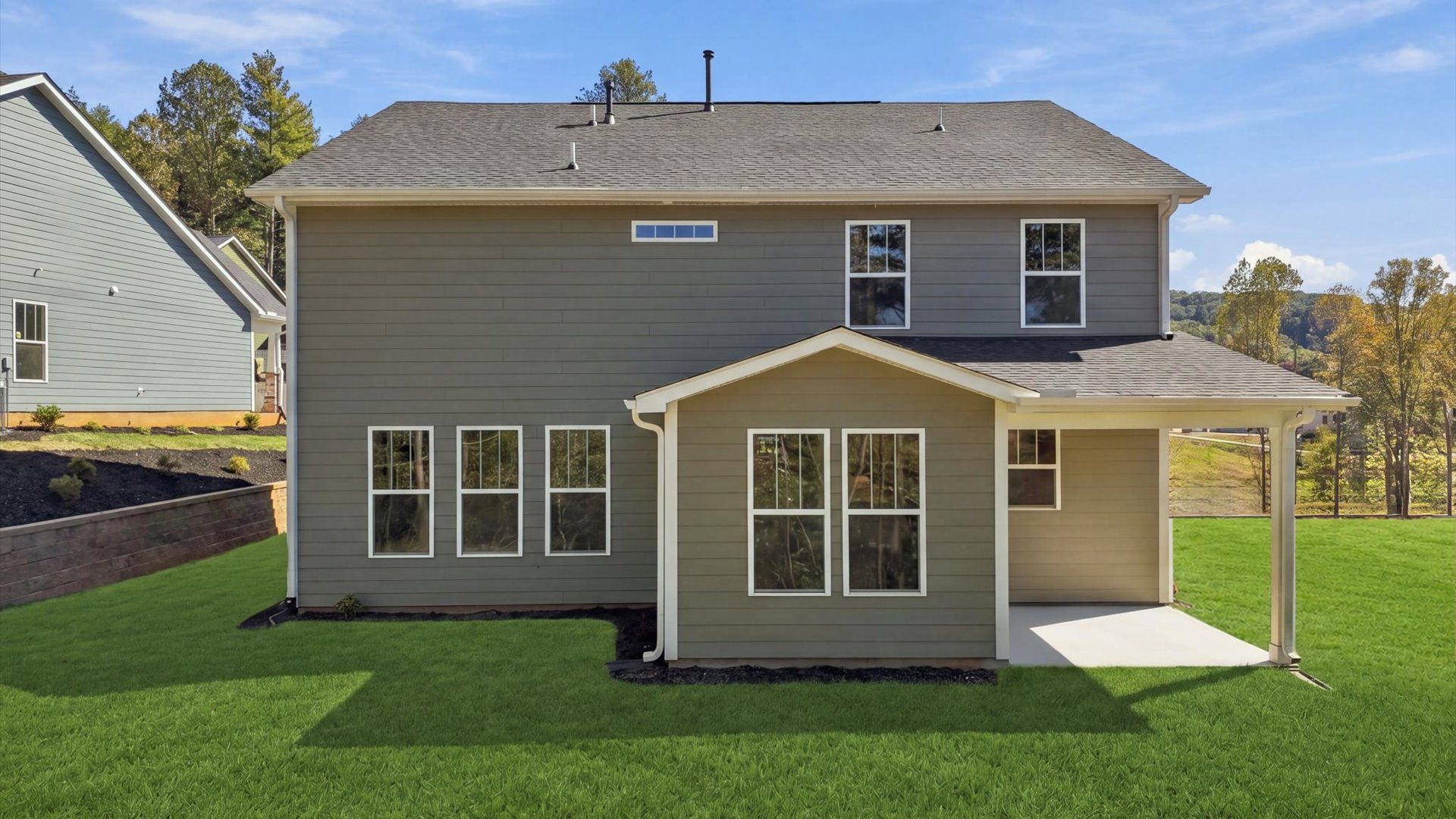 Refined rear exterior with a stylish covered porch for dining, relaxing, or entertaining at The Wilds at Cedar Mountain