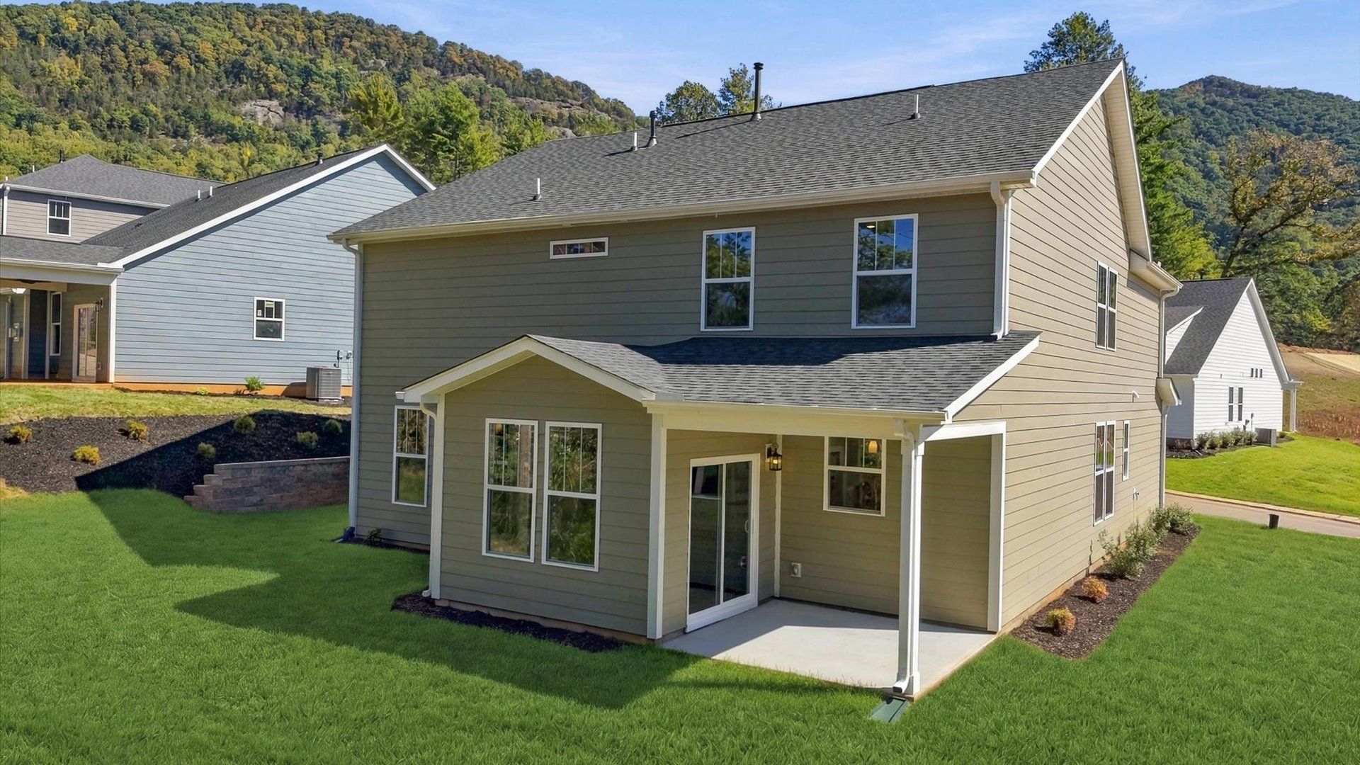 Vibrant rear outdoor space featuring a covered porch and exceptional craftsmanship in Asheville, NC