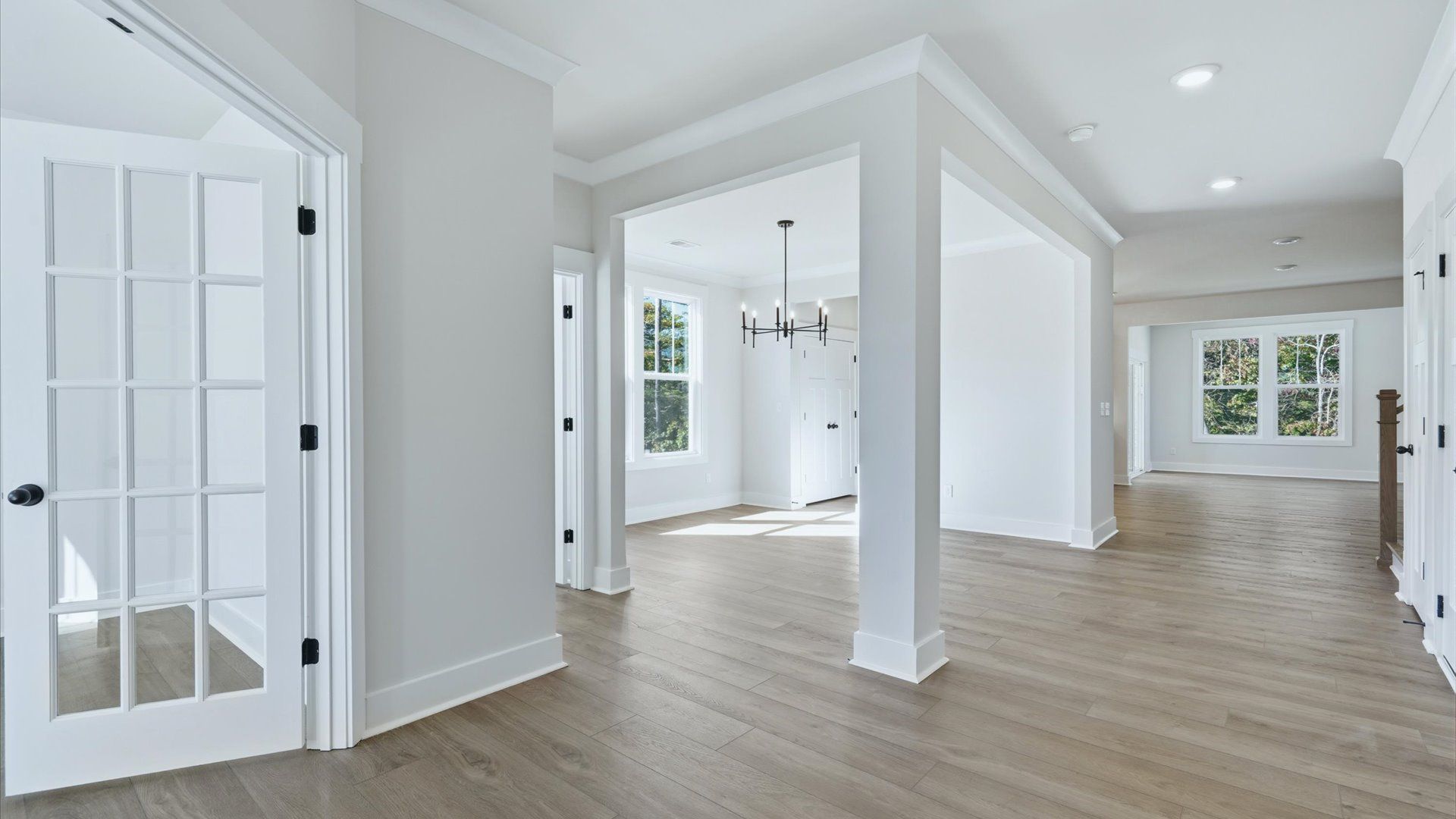 Accomplished hardwood flooring foyer sets the tone for tasteful design throughout the home by DRB Homes
