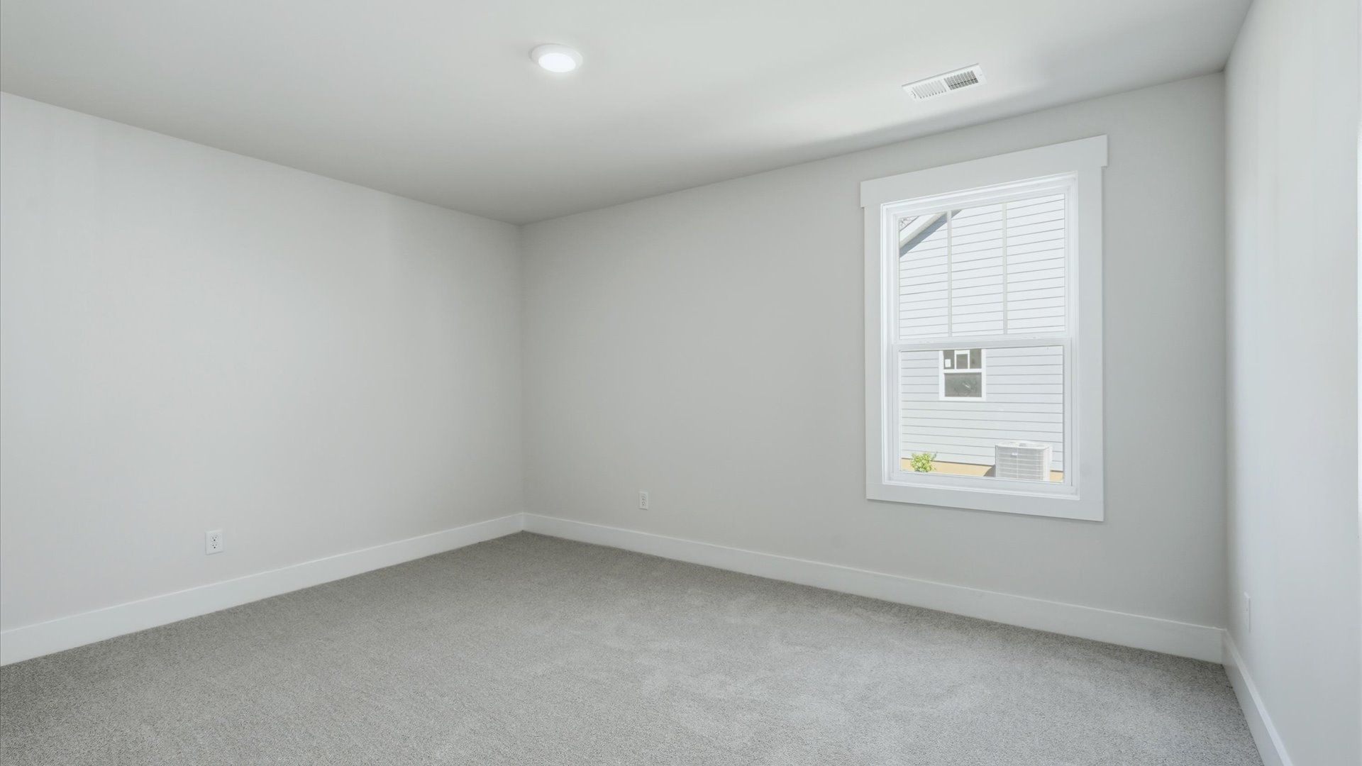 First-rate bedroom with plush carpeting and large windows that provide an open, airy feel located in Asheville, NC