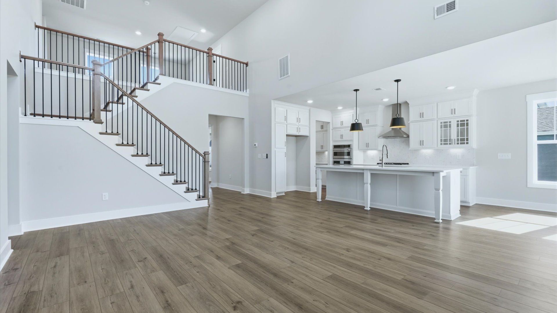 Highly skilled craftsmanship and modern elegance meet in this family room with soaring ceilings near Lake Hartwell