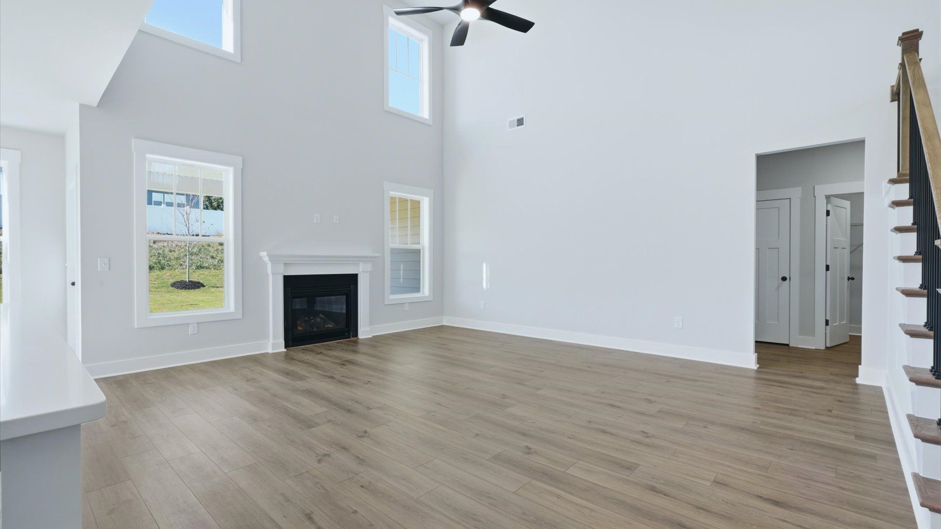 Spacious and stylish family room with two-story ceilings that create a bright and open atmosphere at Kayfield at Midway