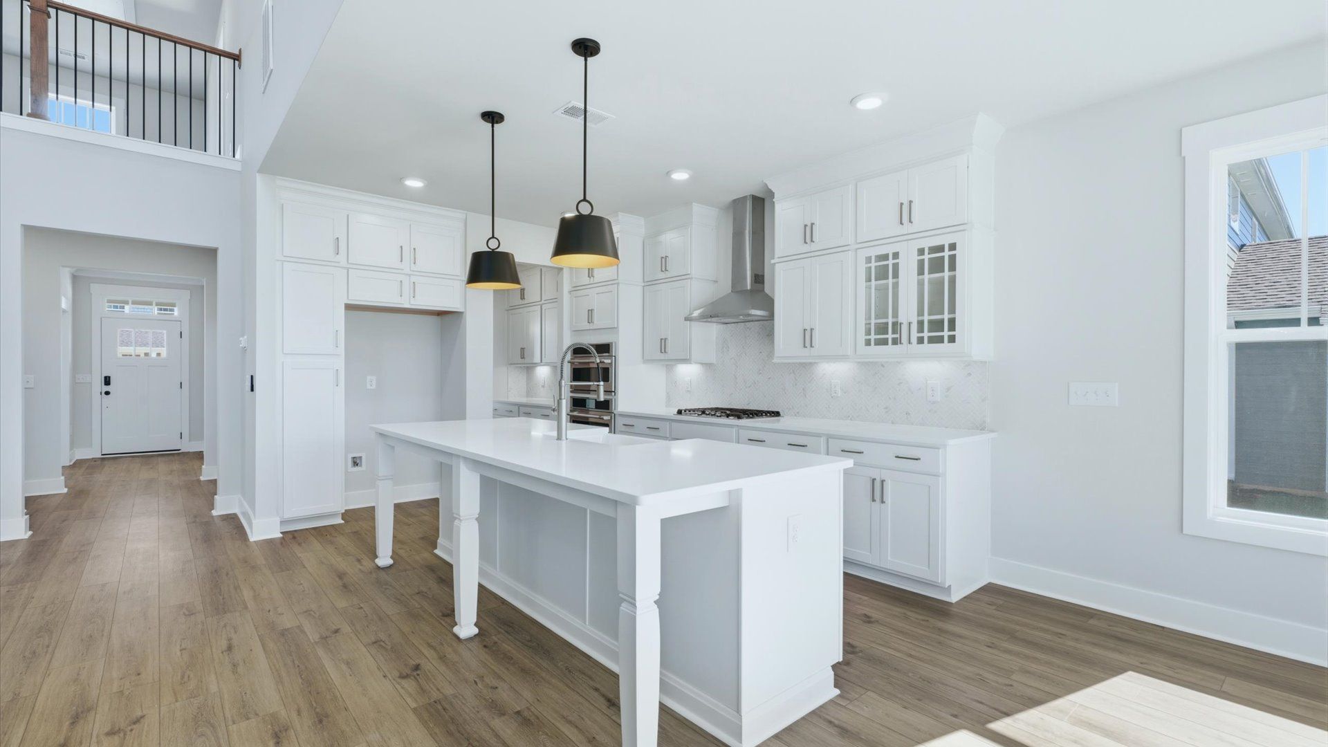 Bright and airy culinary space with generous prep areas and contemporary lighting by DRB Homes