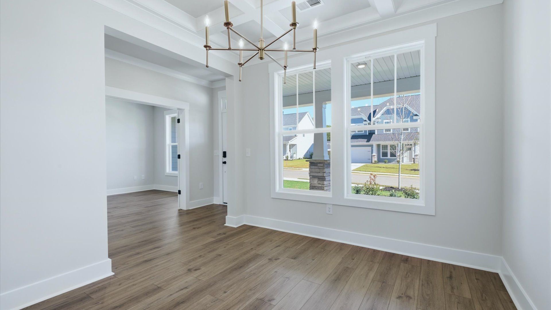 Dining room with coffered ceiling detail that adds warmth and architectural character at Kayfield at Midway