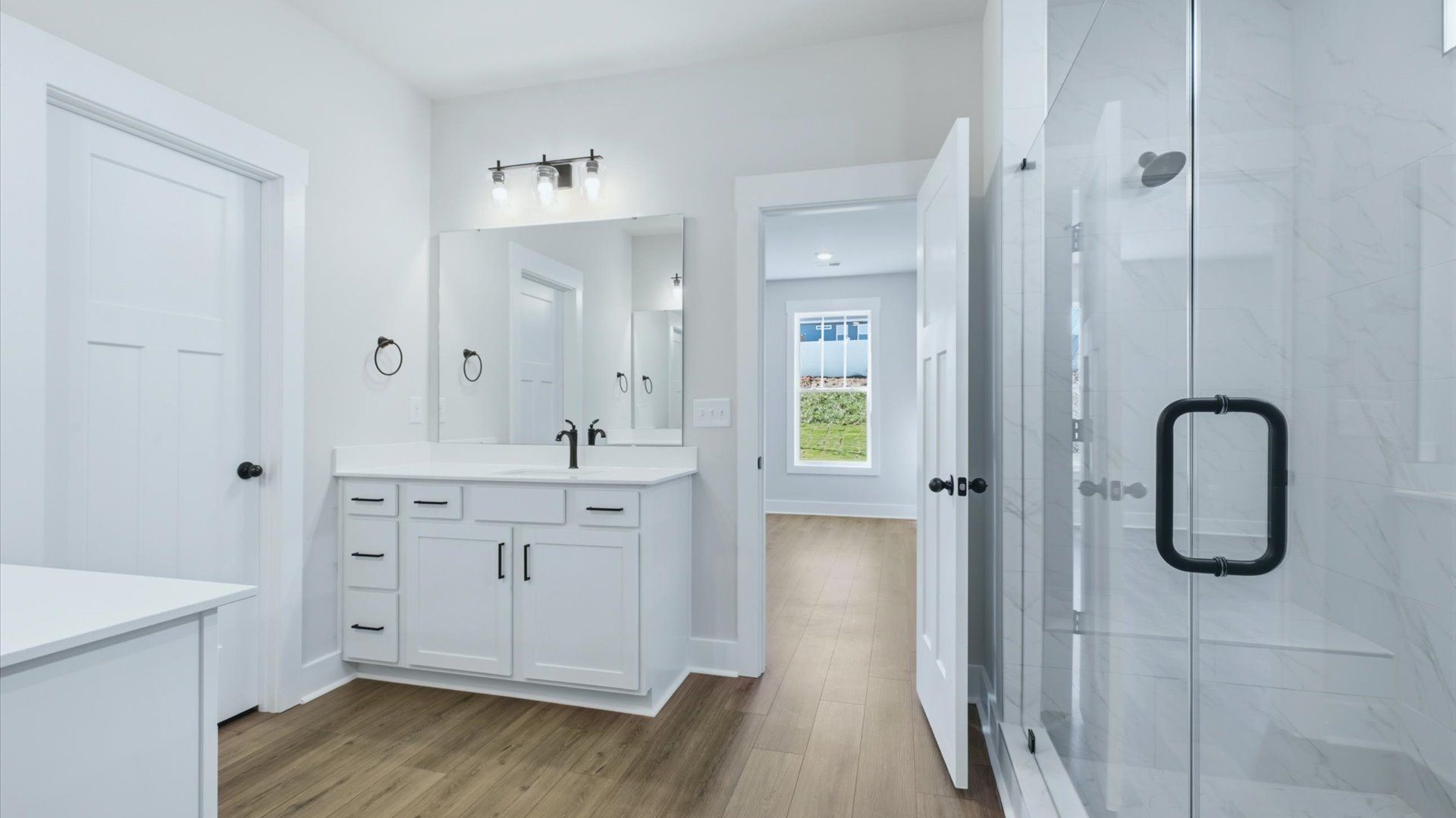 Spacious and modern primary bathroom with walk-in shower and first-class double vanity setup at Kayfield at Midway