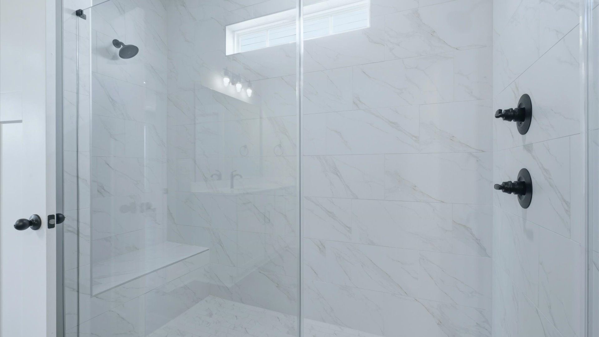 Memorable mornings begin in this elegant primary bathroom with spacious walk-in shower located near Downtown Anderson