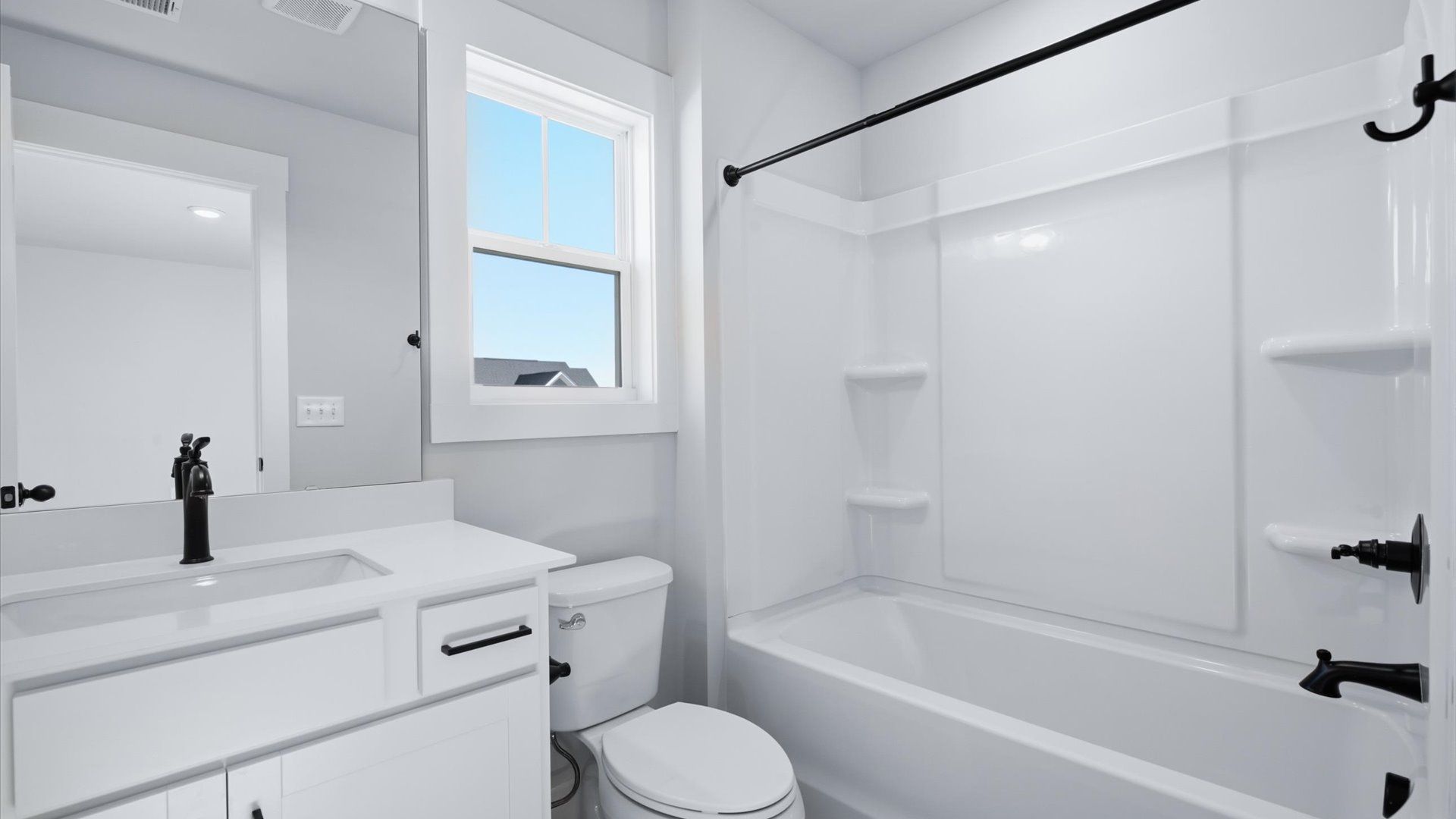 Top-notch bathroom with current fixtures, tasteful materials, and elevated charm by DRB Homes