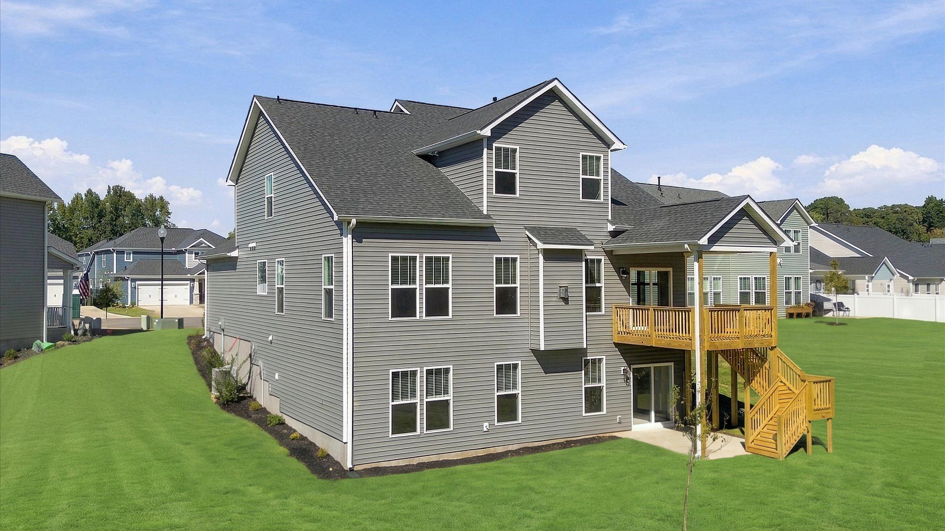 Exceptional outdoor living begins with a covered back porch and deck in this thoughtfully designed home in Easley, SC