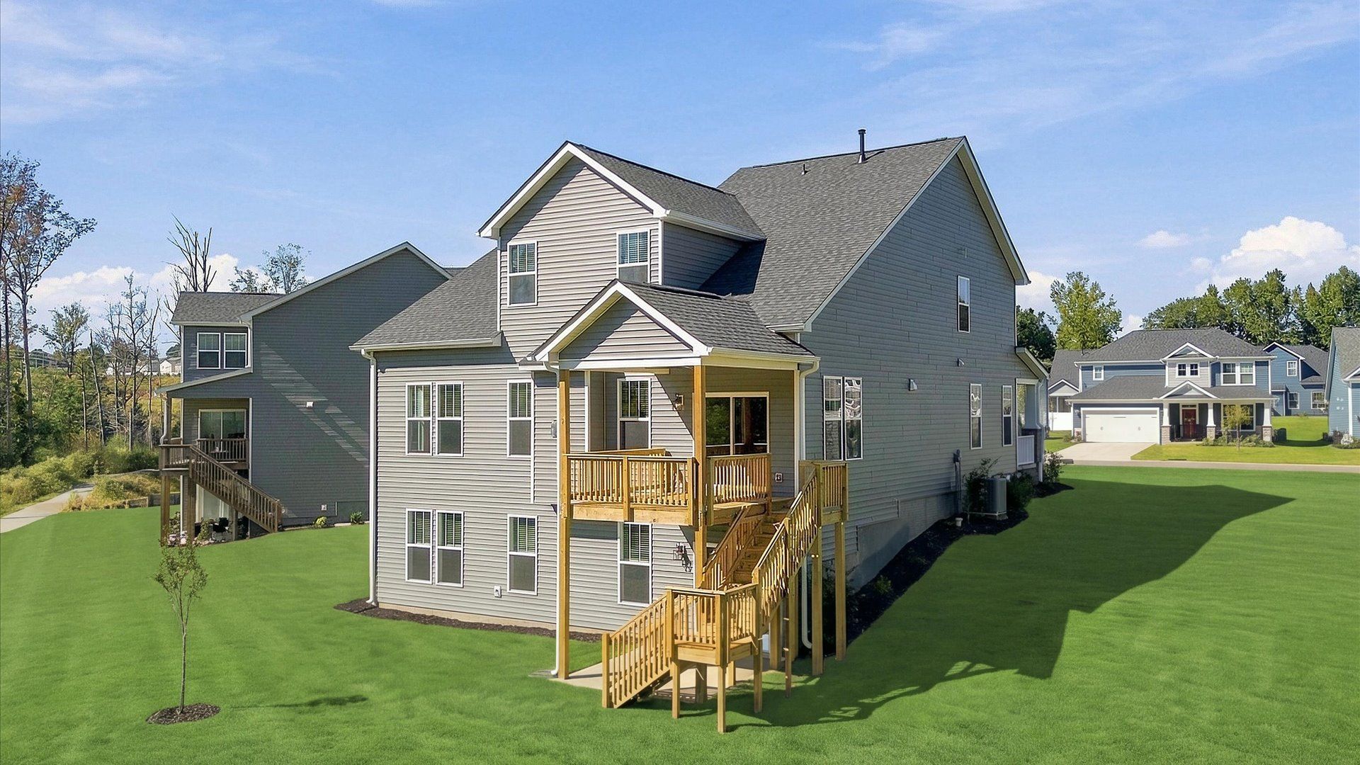 Established charm meets functional outdoor living with a spacious rear covered porch and deck by DRB Homes