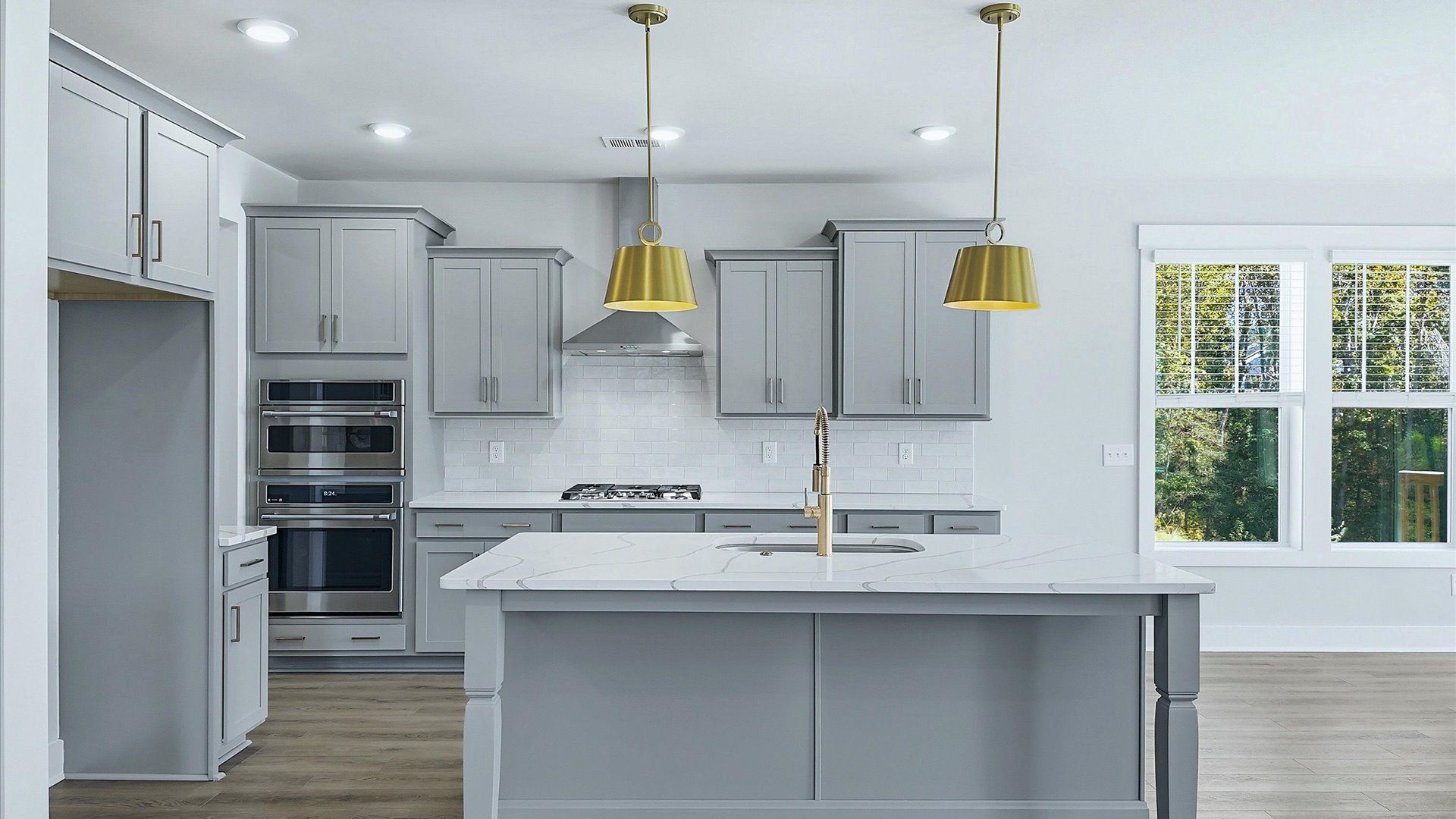 Vibrant kitchen layout with a center island, refined finishes, and open-concept flow by DRB Homes