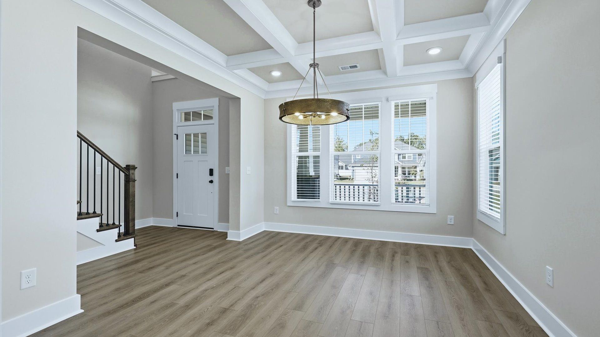 Desirable dining room with coffered ceiling and modern elegance in an established community by DRB Homes