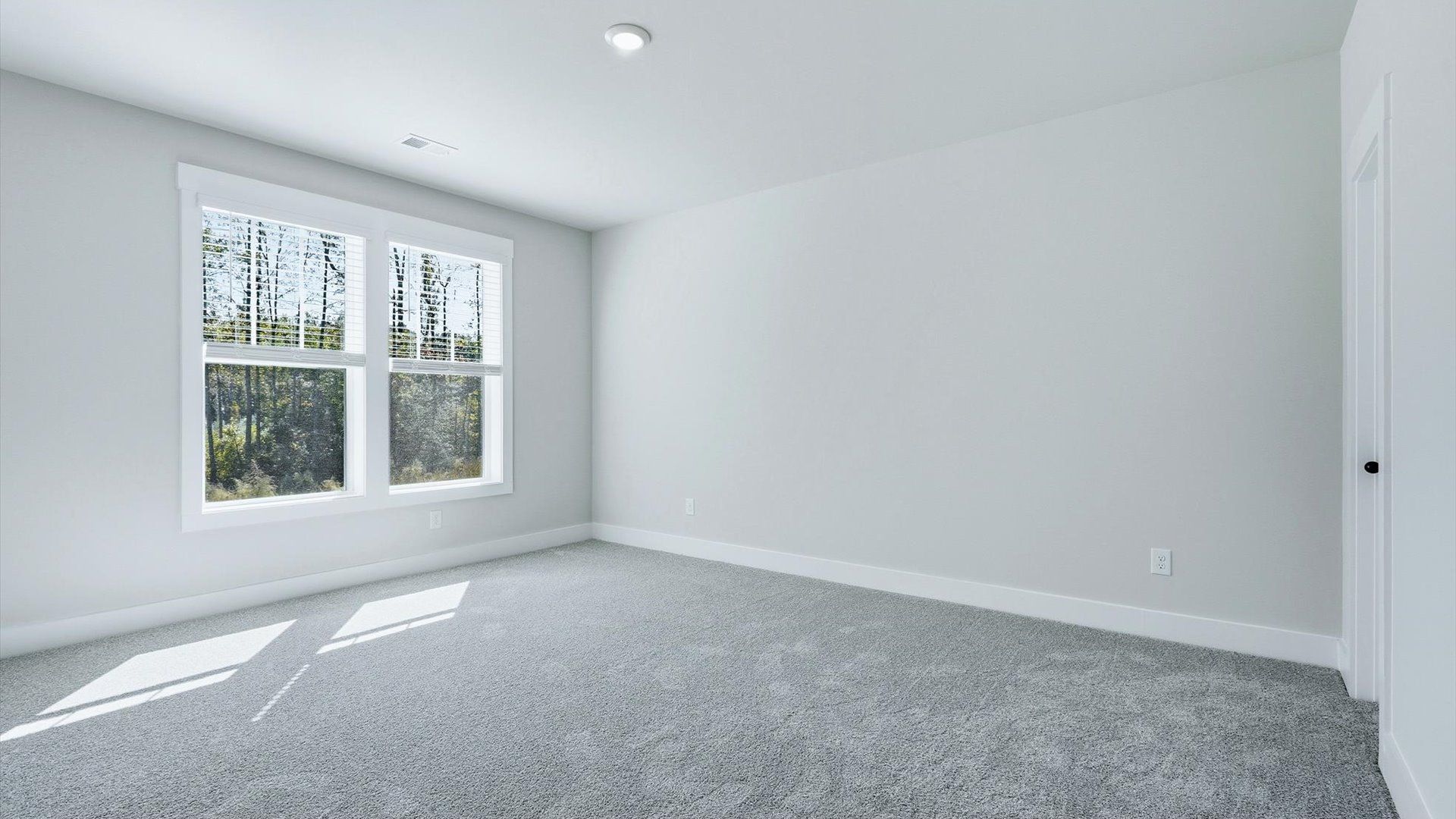 Inviting bedroom with tasteful finishes and large windows that create a fresh, open ambiance at Livingston Park