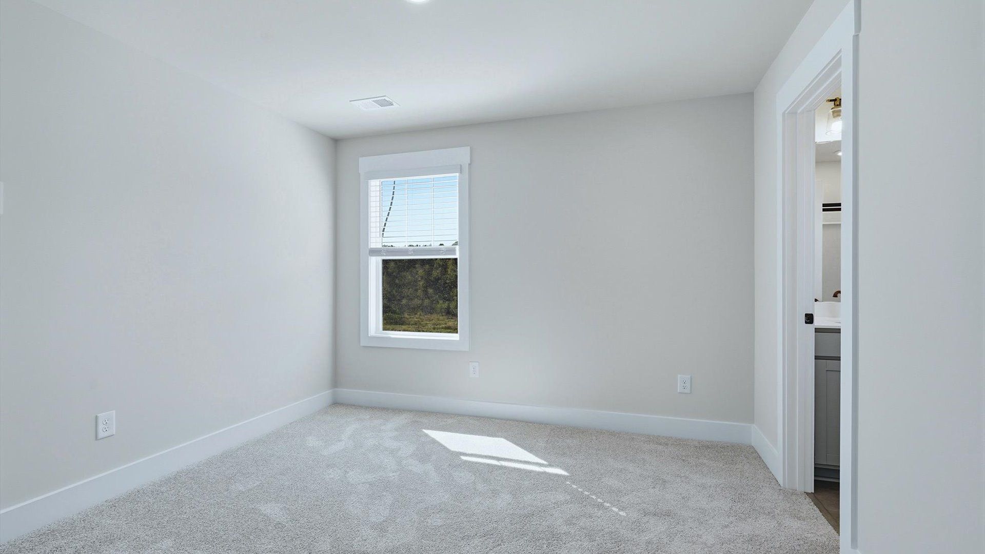 Accomplished design in this restful bedroom featuring plush carpet and oversized window views