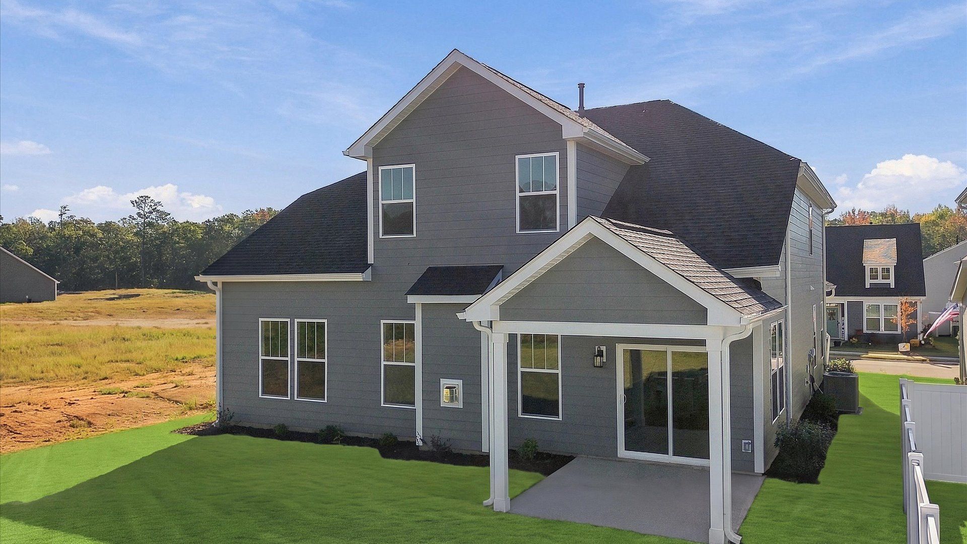 Warm and inviting outdoor living space with a covered rear porch and tasteful finishes at Mulberry Estates