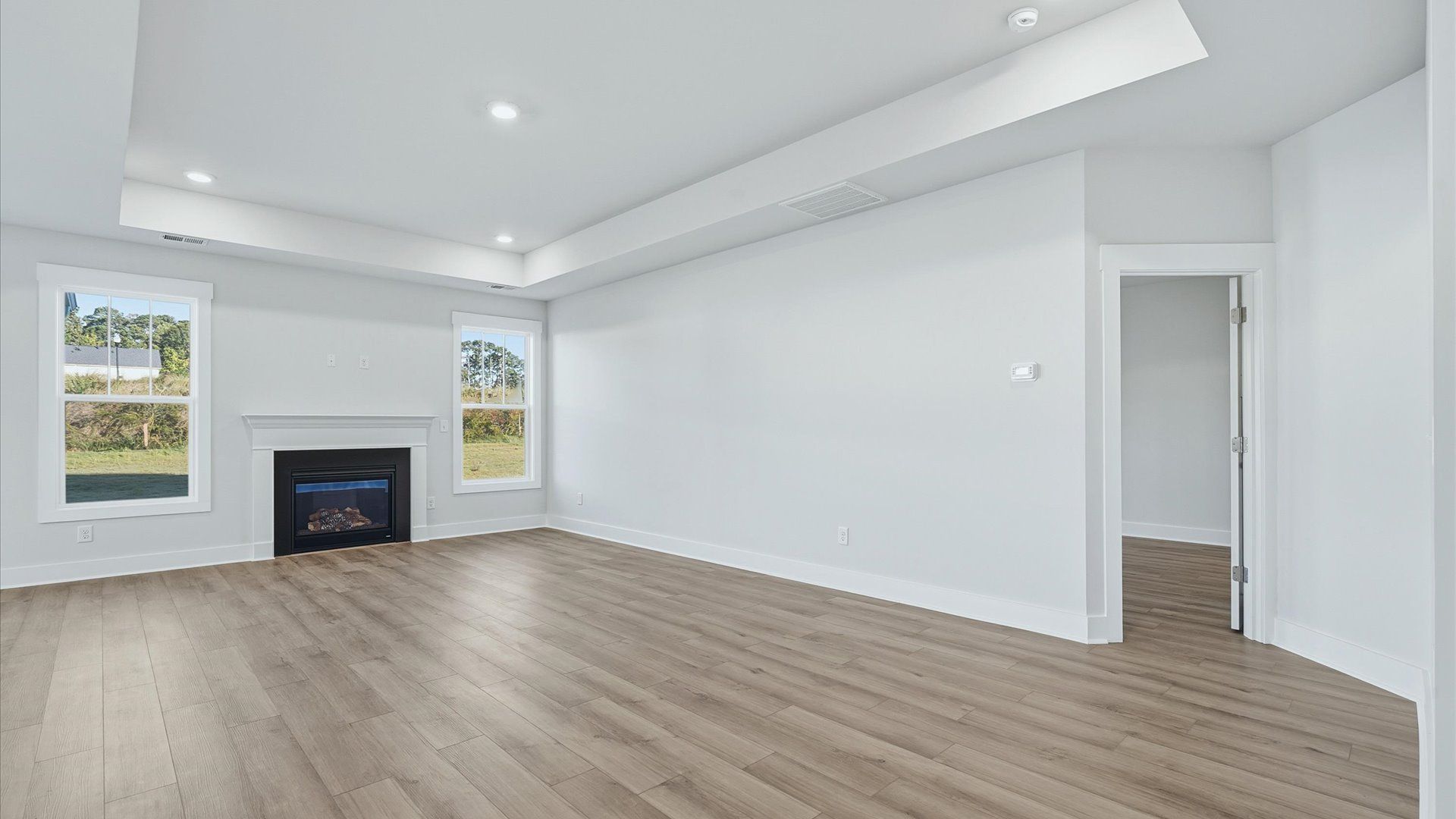 Tasteful family room with tray ceilings, modern fixtures, and a warm, inviting feel located near Downtown Simpsonville