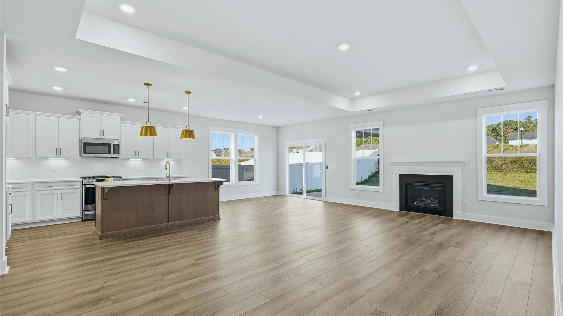 Memorable moments begin in this elegant, open family room with hardwood flooring and refined finishes by DRB Homes
