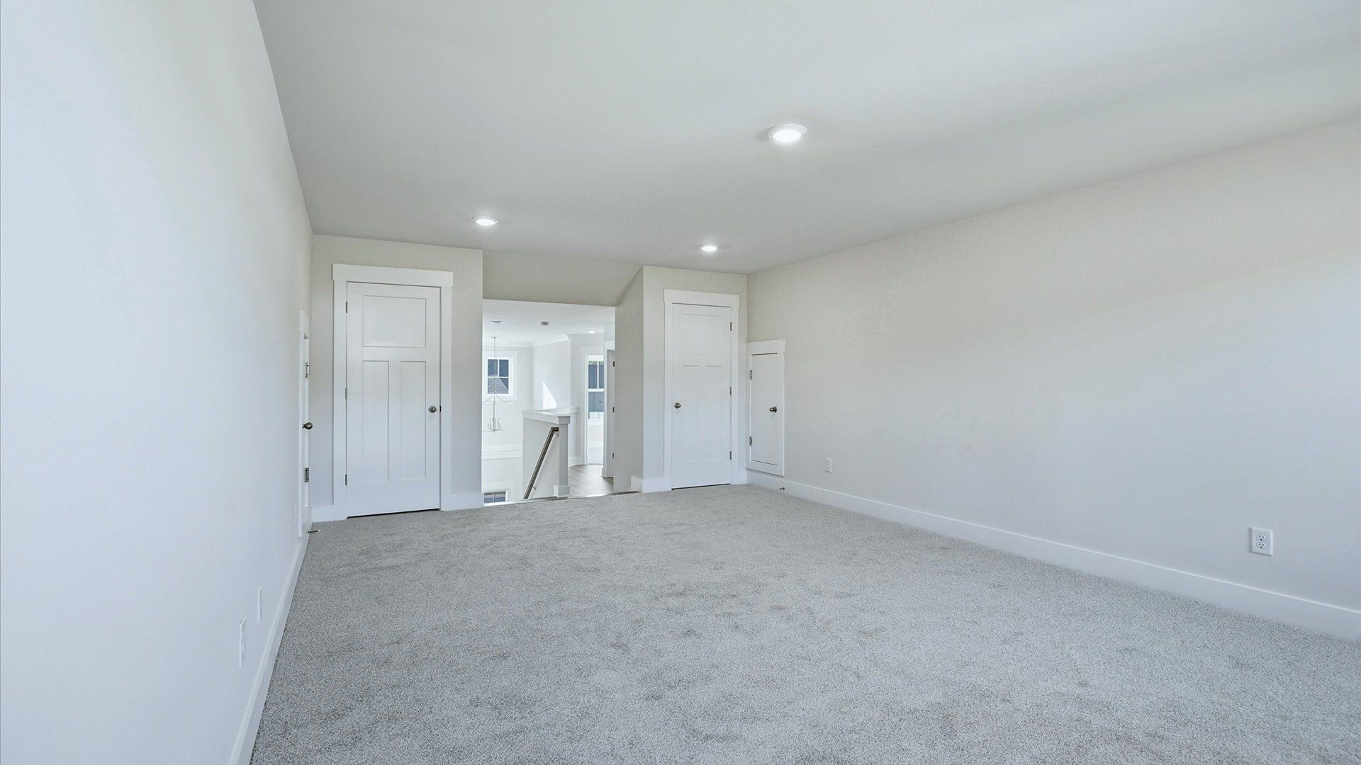 Refined bonus room with comfortable carpeted flooring and tasteful design throughout by DRB Homes