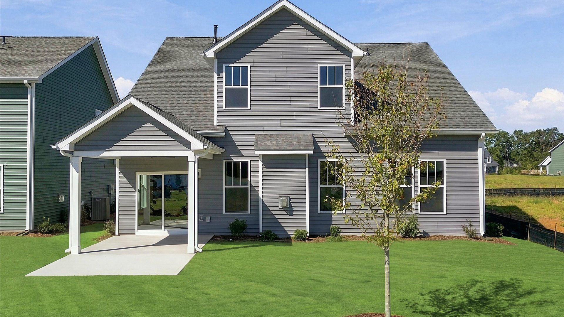 Refined rear exterior with a stylish covered porch for dining, relaxing, or entertaining located in Inman, SC
