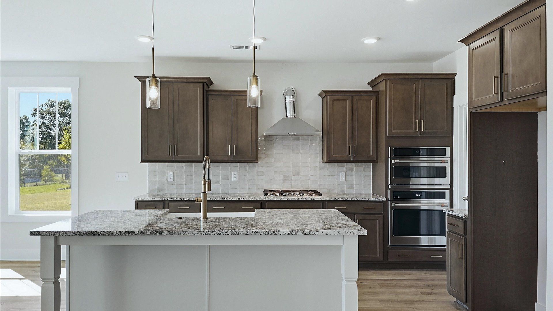 Memorable meals begin in this vibrant kitchen with pendant lighting and a thoughtfully designed island in Inman, SC