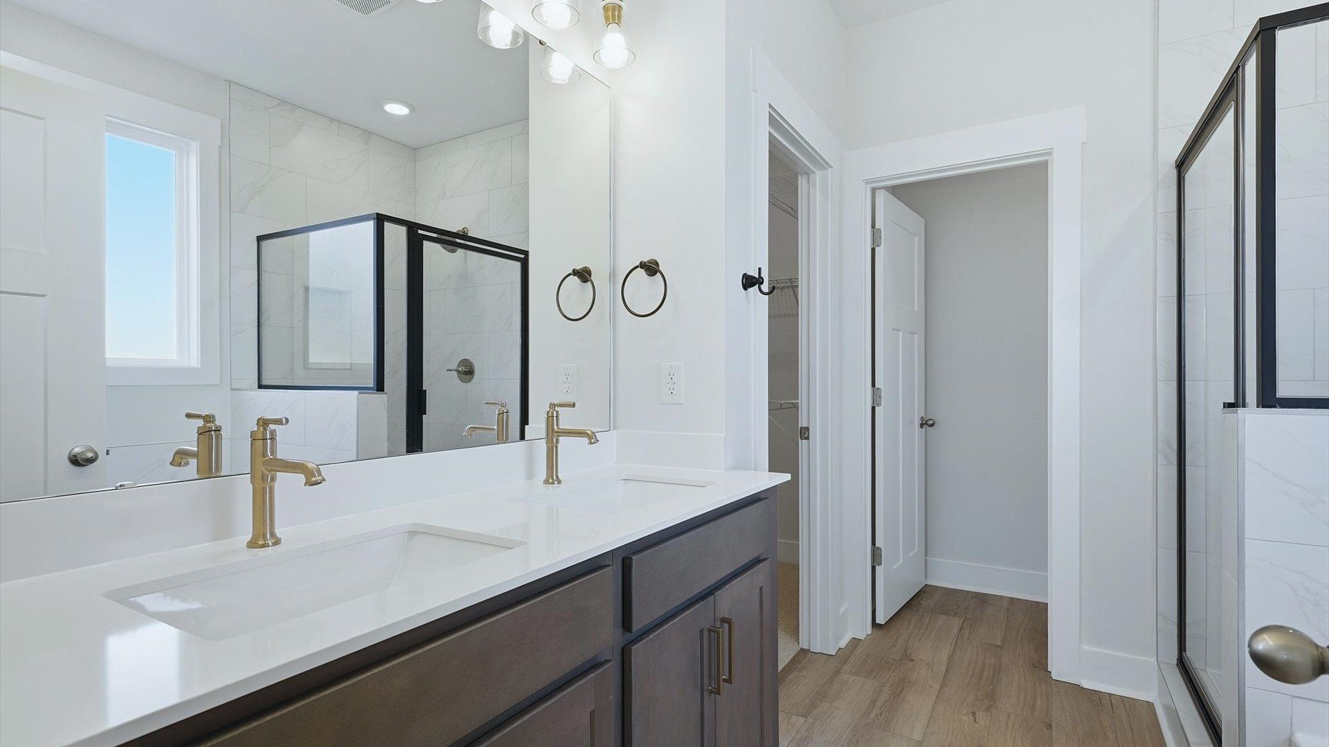 Notable primary bath featuring dual vanity, walk-in shower, and tasteful design touches throughout at Walnut Ridge