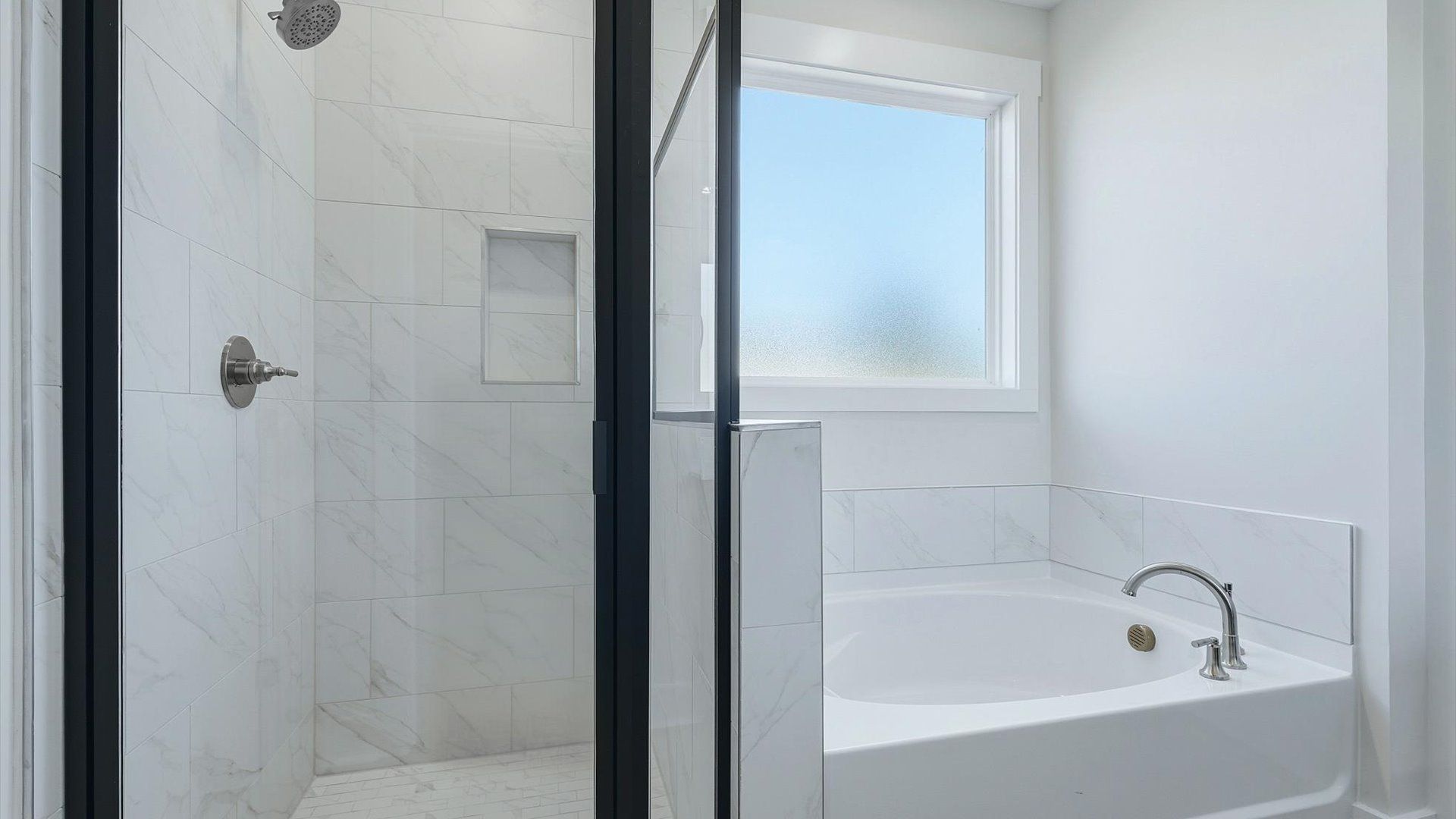 Memorable mornings begin in this elegant primary bathroom with walk-in shower and soaking tub located in Inman, SC