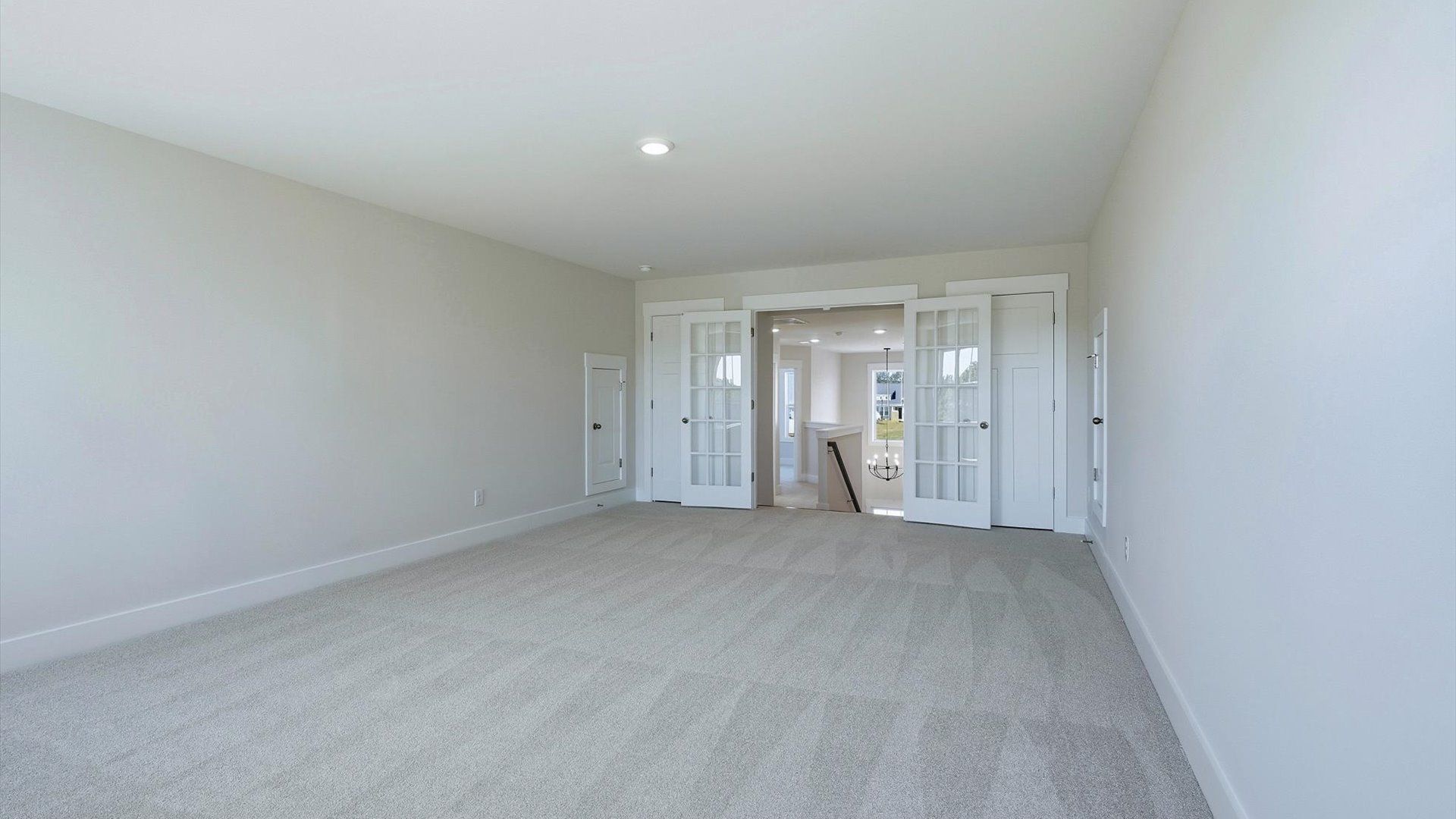 Vibrant carpeted bonus room offering flexibility as a study nook, game room, or second family space by DRB Homes