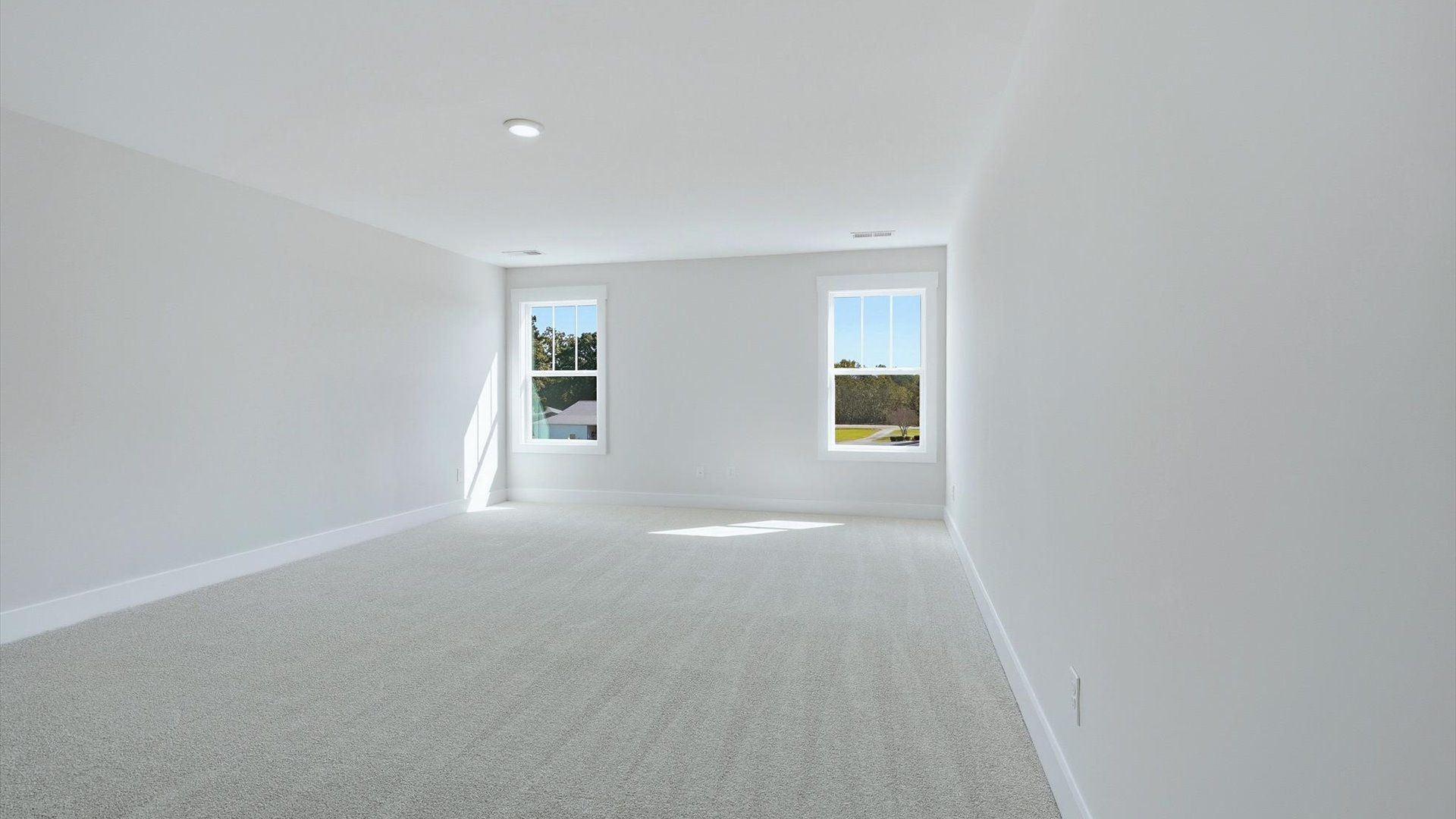 Top-notch design defines this bonus room with carpeted floors and an open, airy layout at the Walnut Ridge community