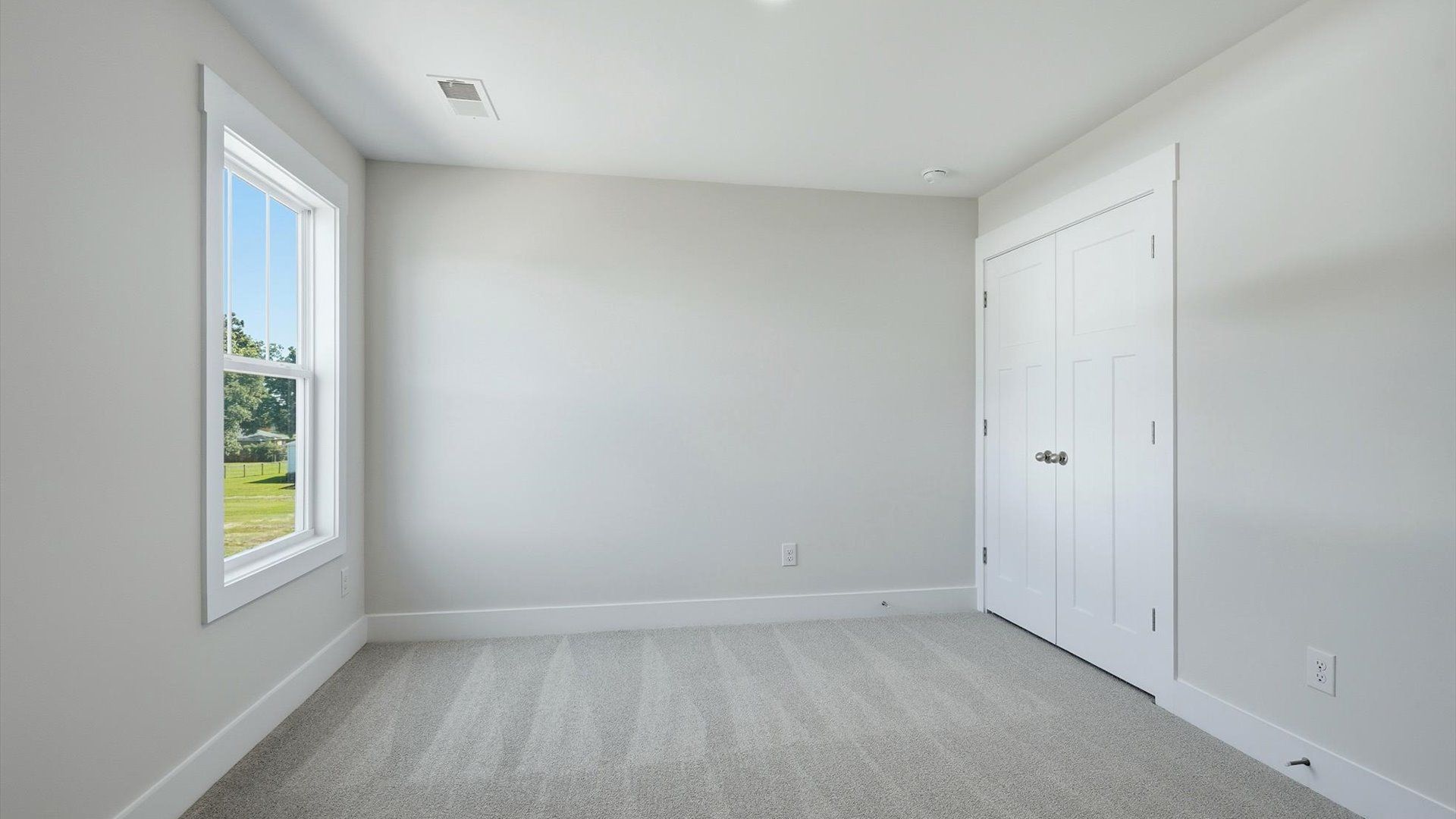 First-class bedroom with generous proportions, a walk-in closet, and beautiful natural light through large windows