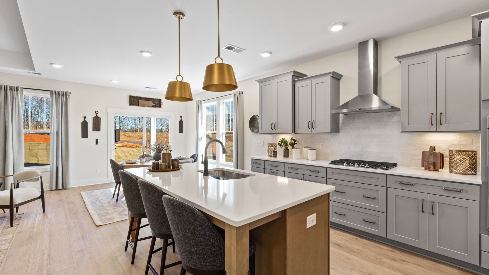 Superior kitchen with quartz countertops, pendant lighting, and a generously sized island at Alexander Place